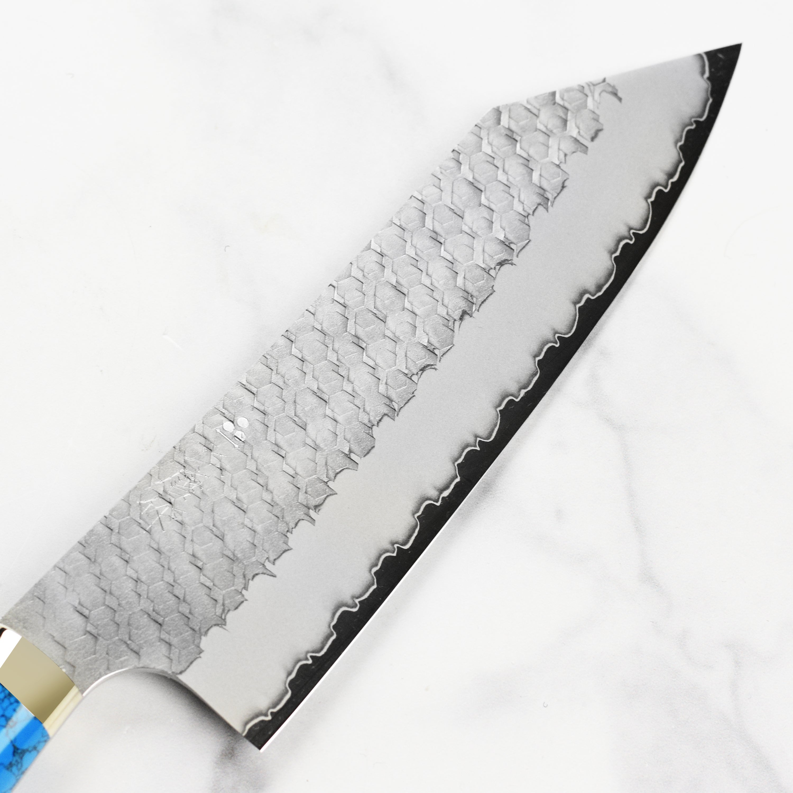 Side view of the Nigara SG2 Migaki Tsuchime 7" Bunka Knife with blue turquoise handle