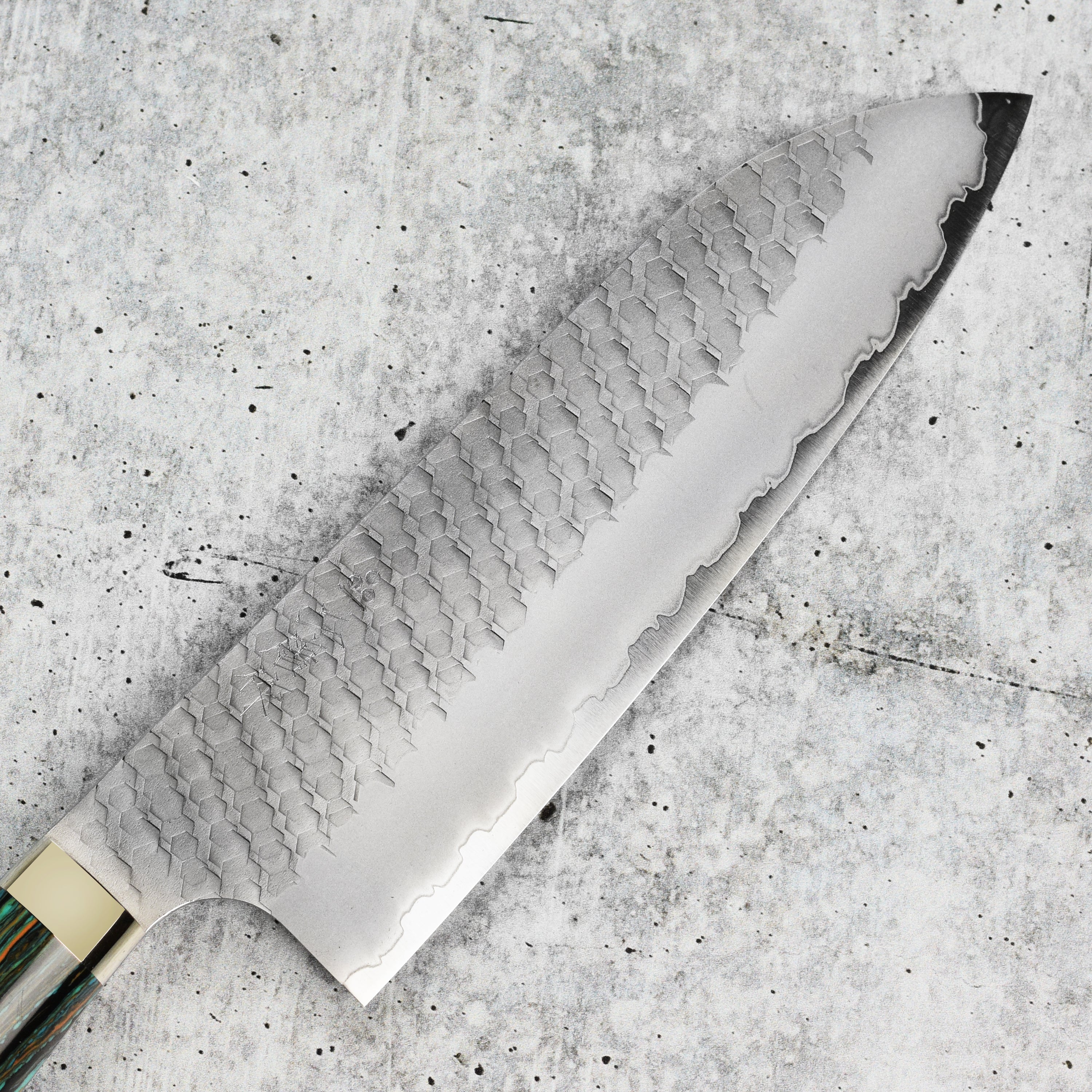 Nigara SG2 Santoku knife with striped turquoise handle on cutting board