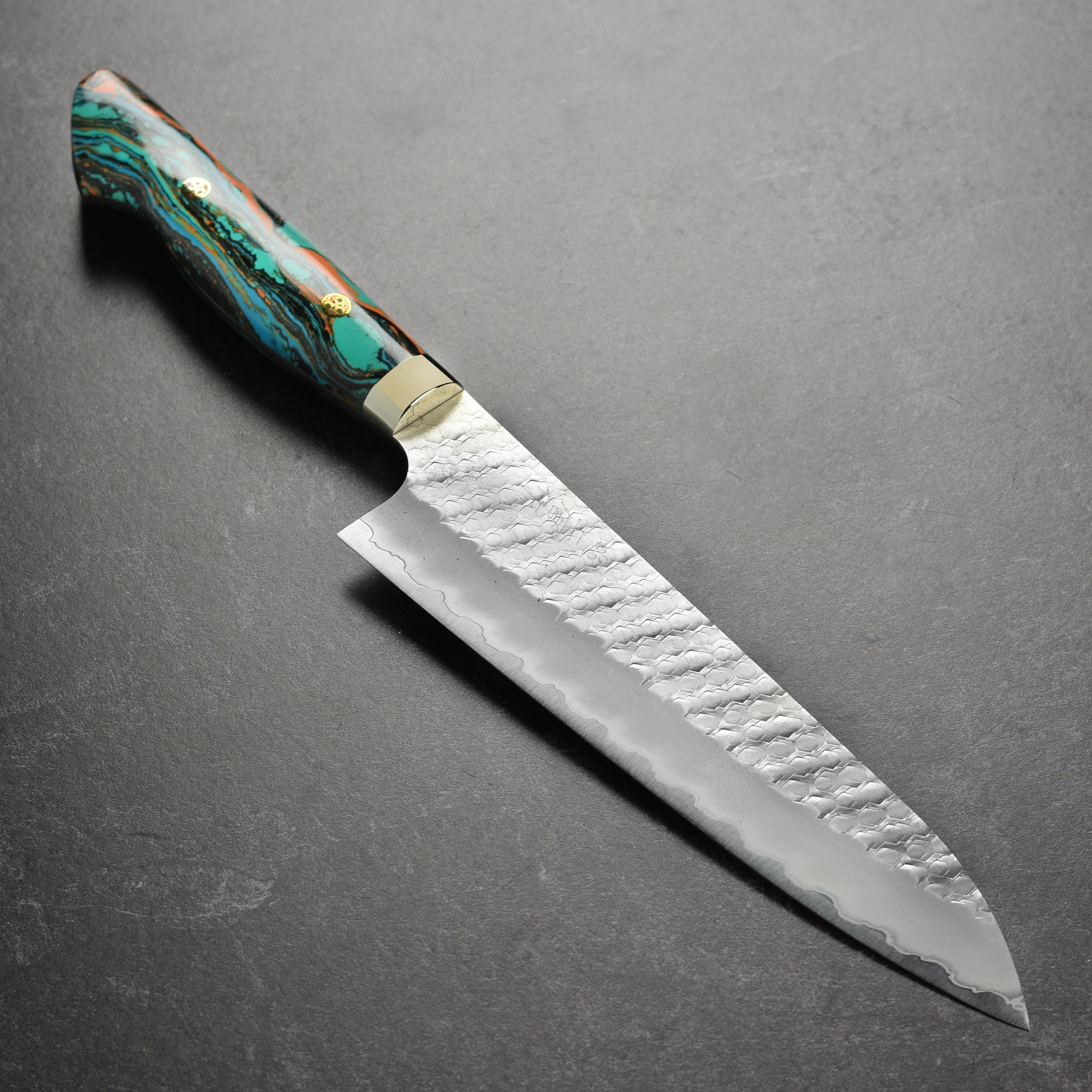 Close-up of Nigara SG2 Gyuto knife blade with tsuchime finish for precision slicing