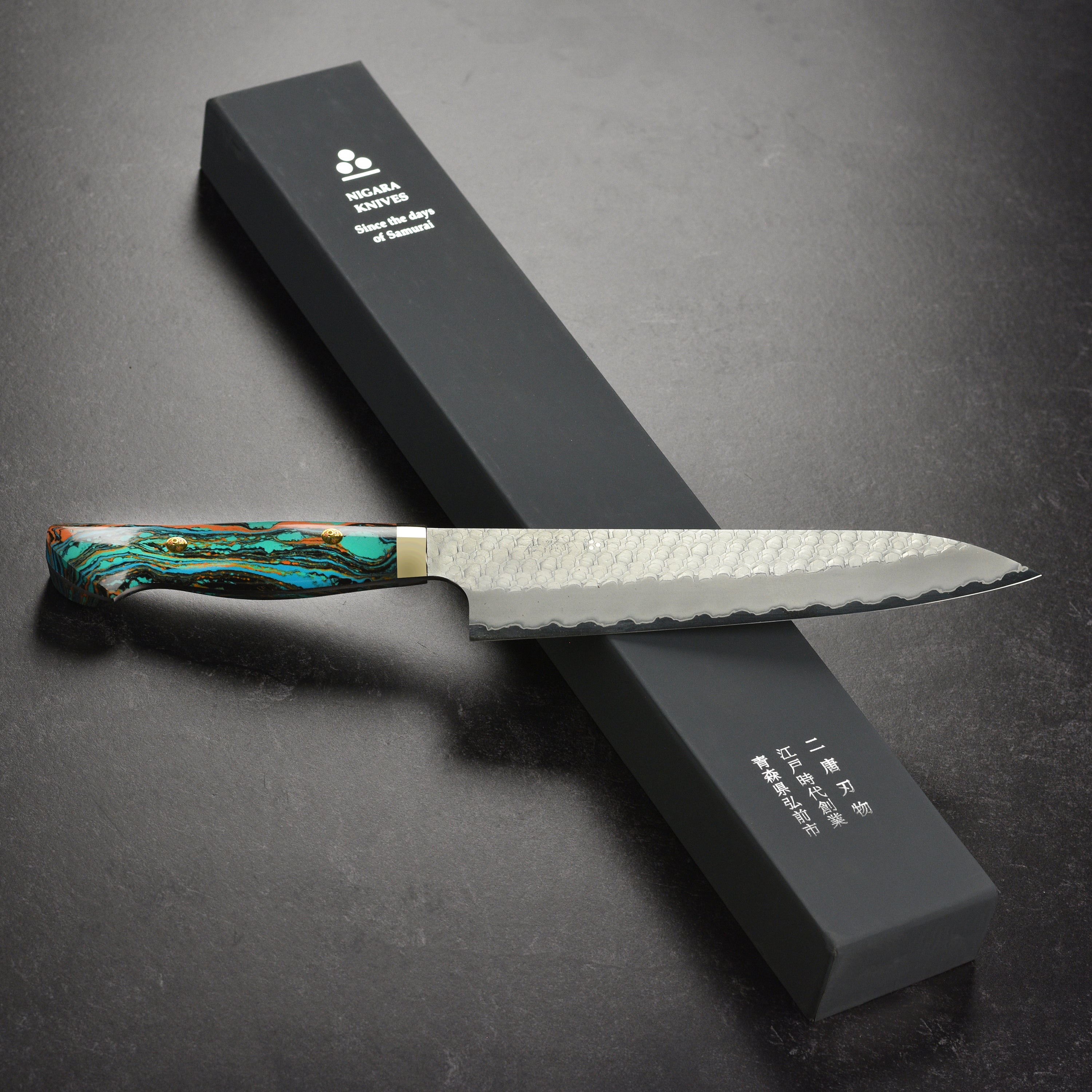 Top view of the Gyuto knife highlighting the turquoise marble handle and sharp edge