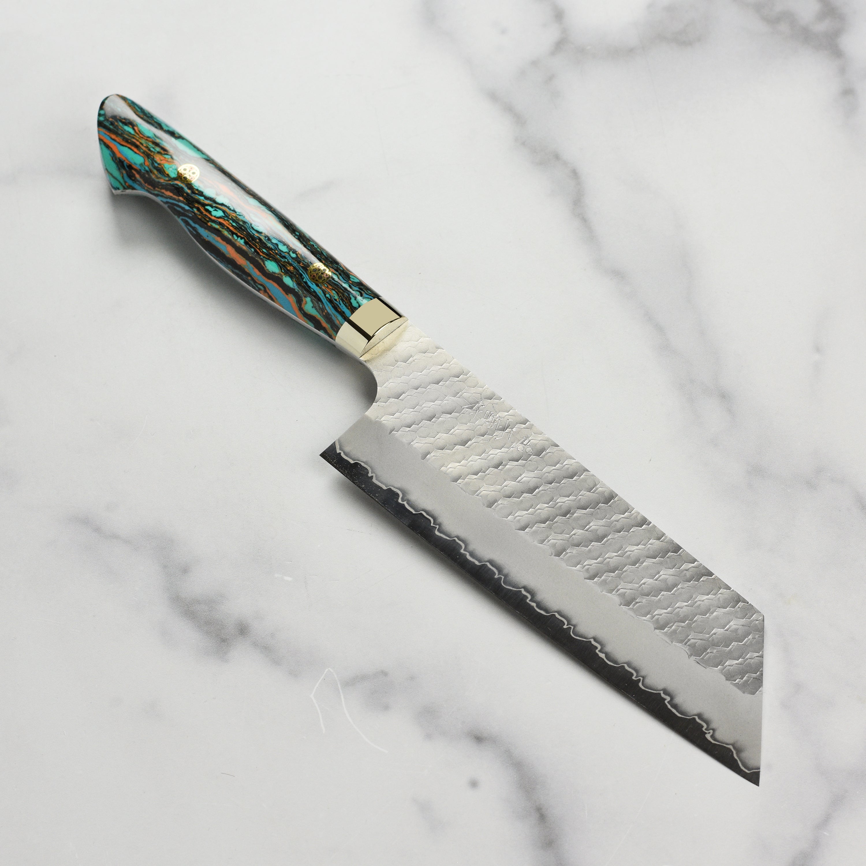 Nigara SG2 kiritsuke nakiri knife showcasing its marbled turquoise handle from above.