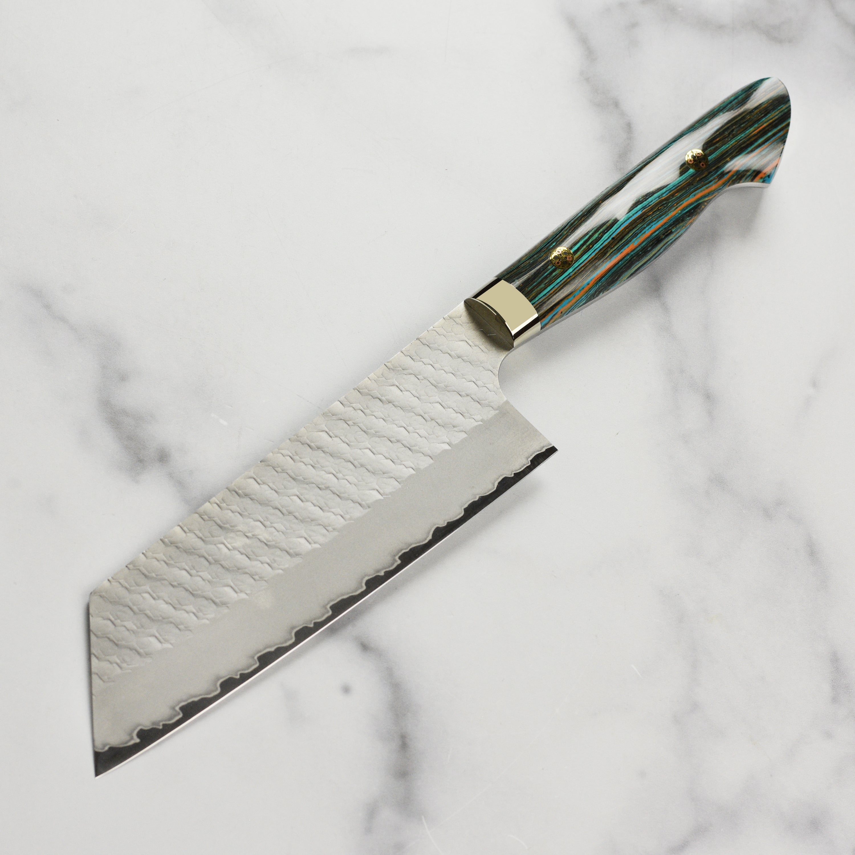 The ergonomic handle of the turquoise striped Nakiri knife, designed for comfort and control.
