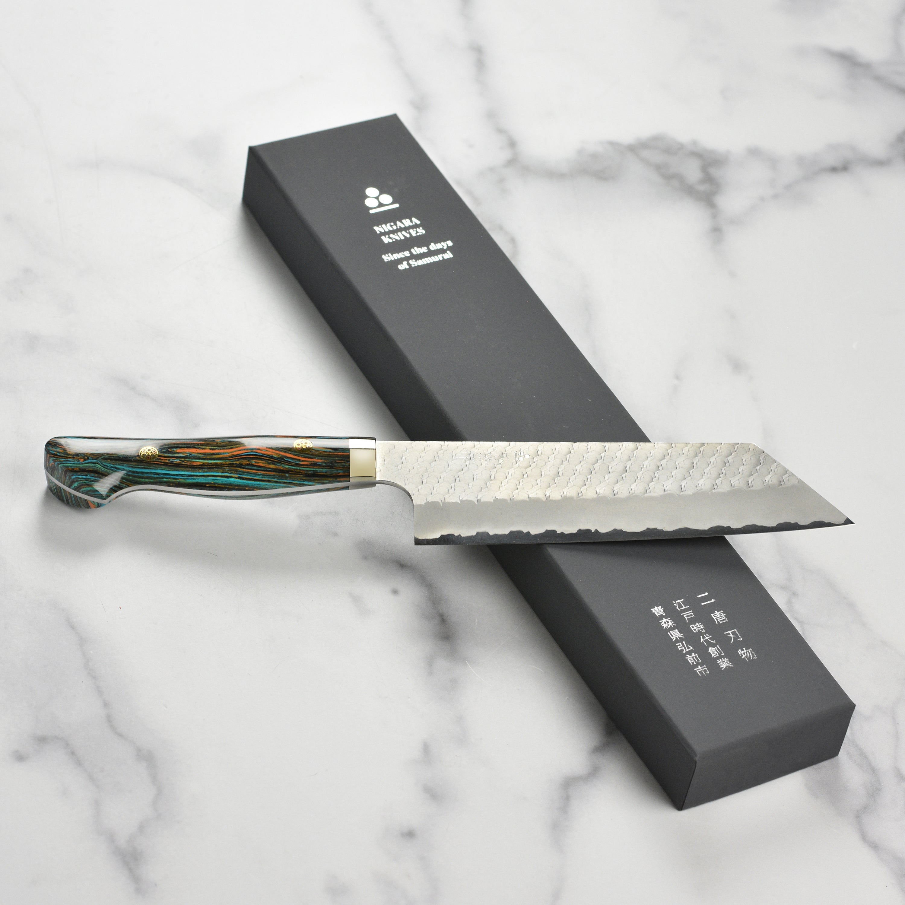 Close-up of the sharp blade of the SG2 Kiritsuke Nakiri knife, perfect for precision cutting.