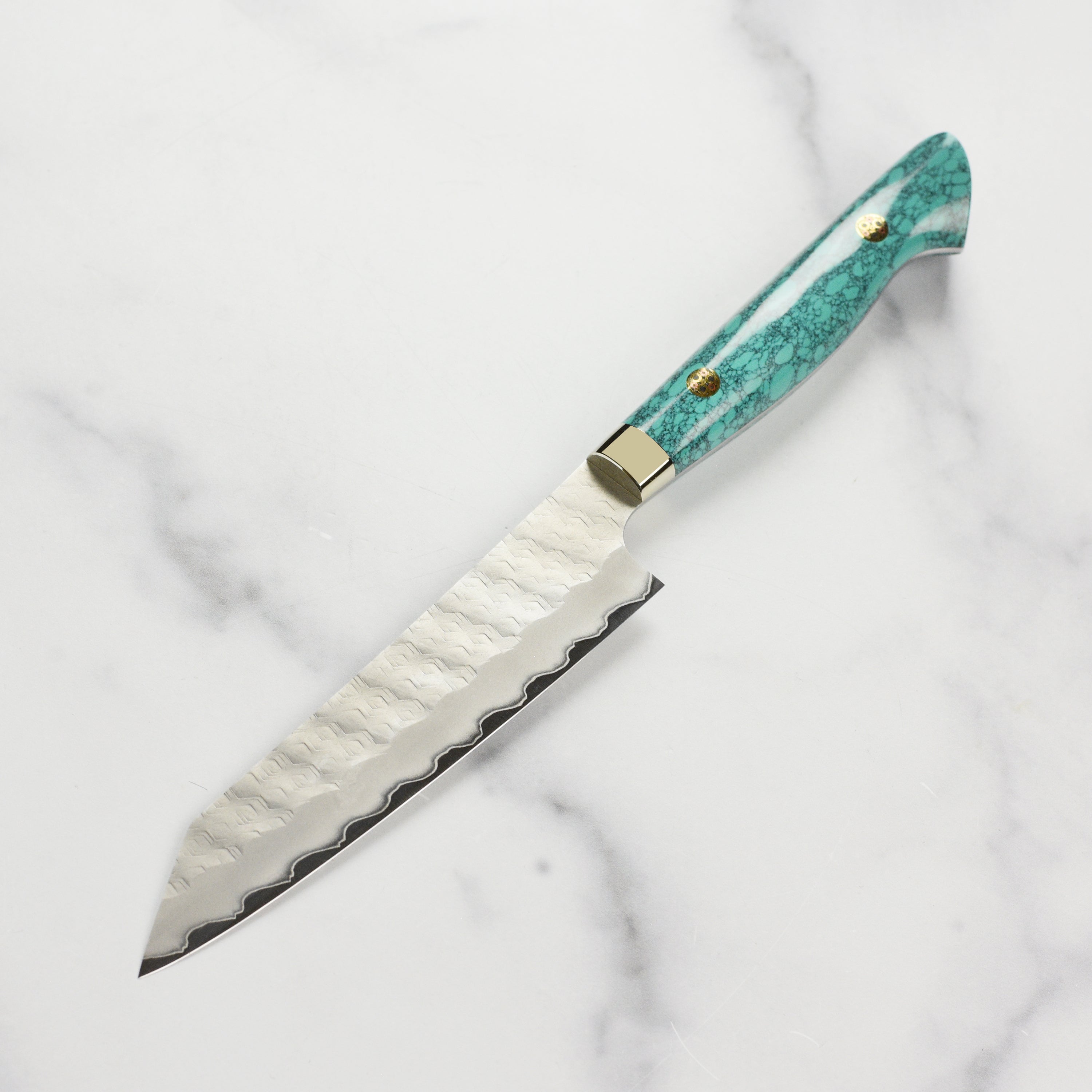 Stylish display of the Nigara SG2 Kiritsuke petty knife next to fresh ingredients, highlighting its design.