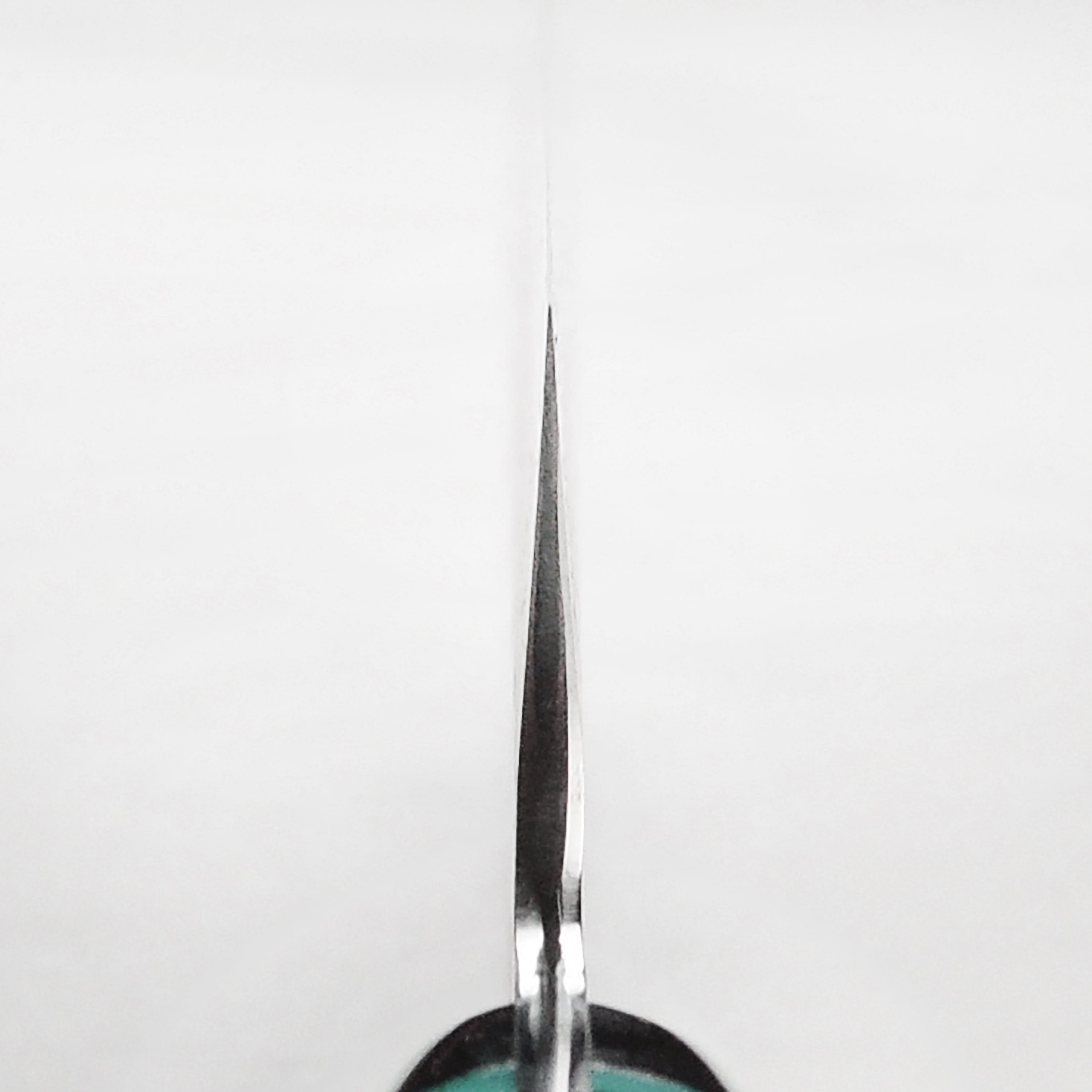 Nigara SG2 Kiritsuke chef knife in use, slicing vegetables with precision.