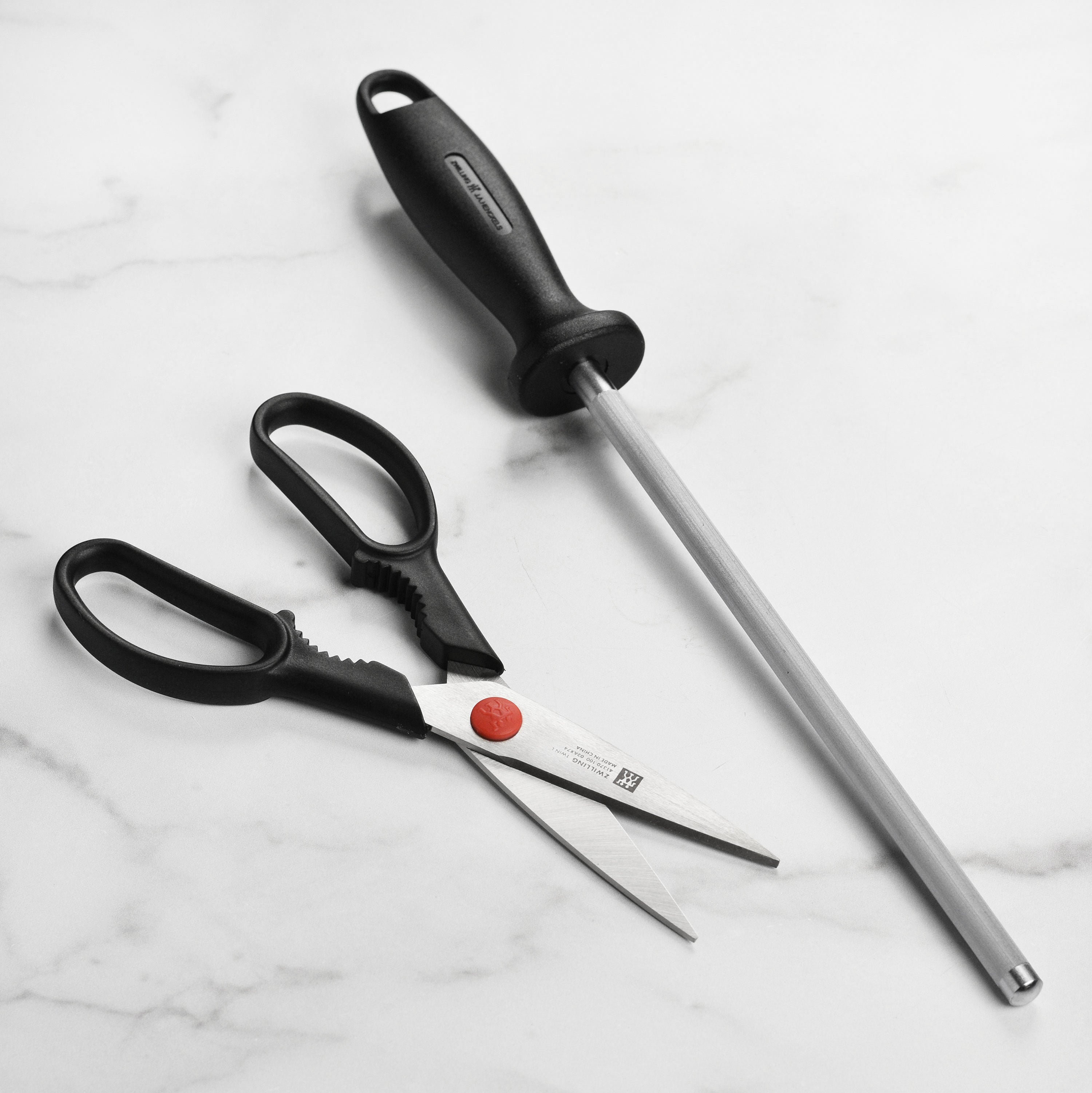 Chef slicing vegetables using a sharp, durable Zwilling knife from the set