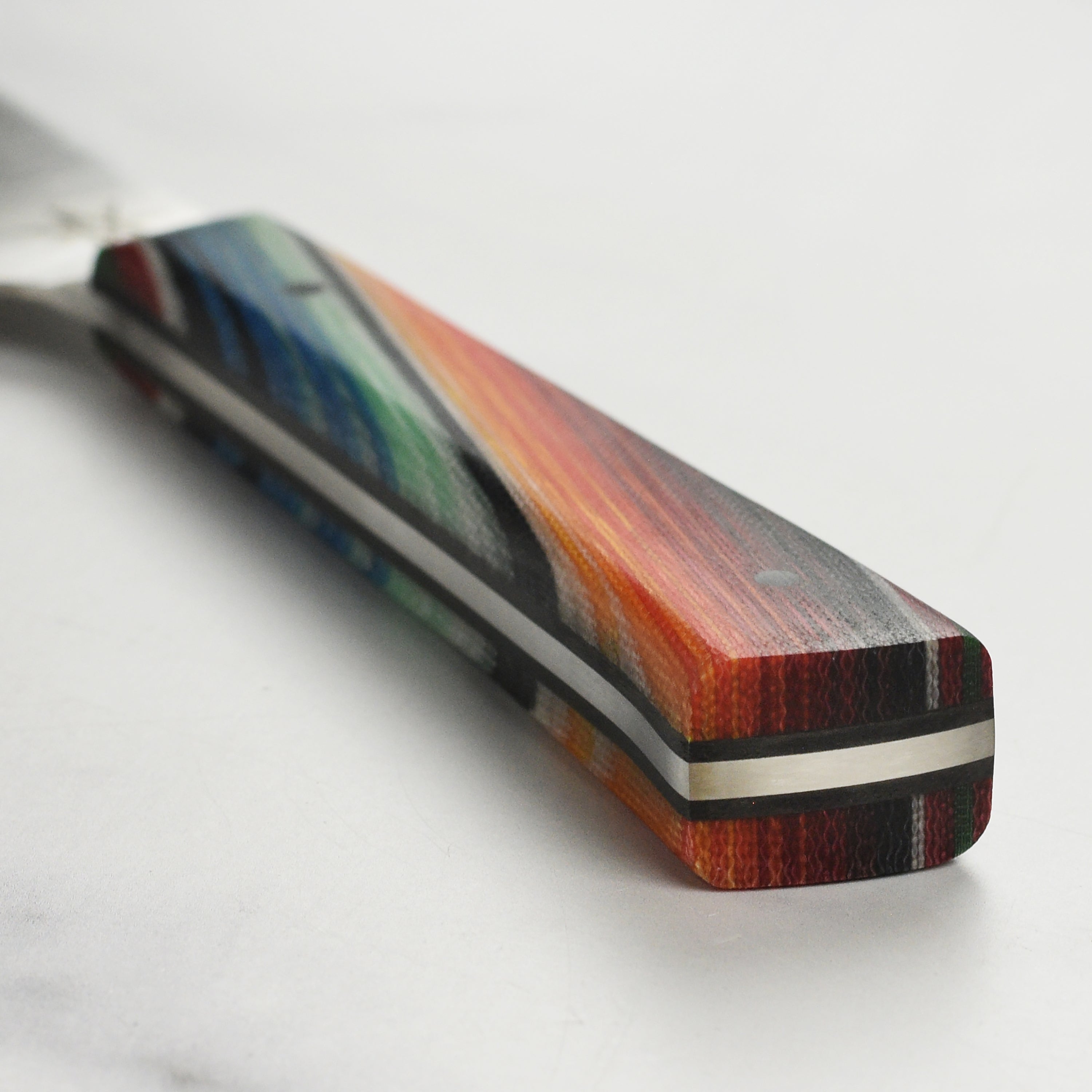 Handmade kitchen knife for effortless meat slicing, featuring a pointed tip and straight spine