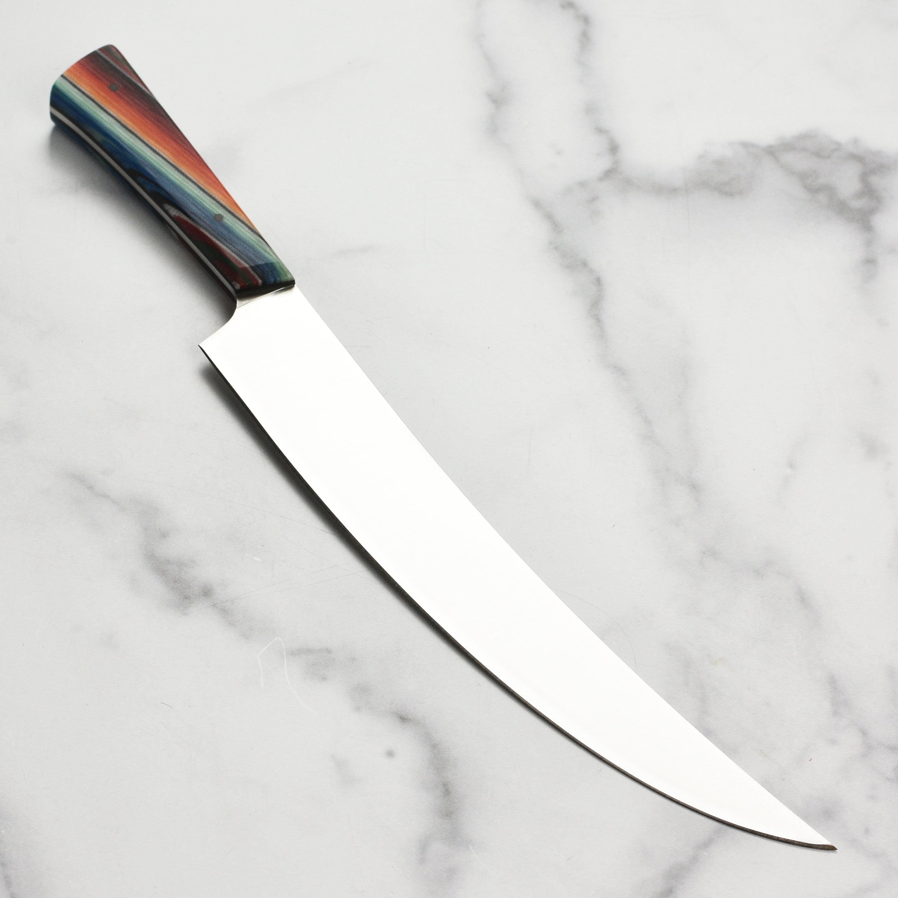 Angled top-down view of the Baja 11" Japanese knife showing curved edge and pointed tip