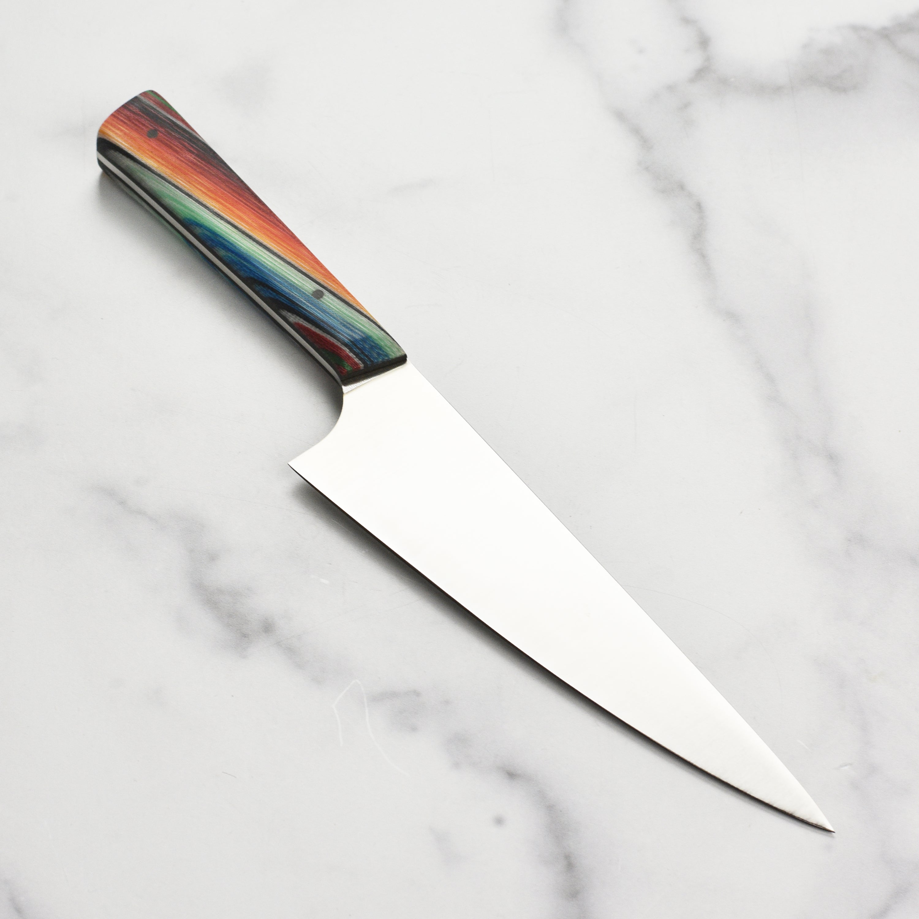 Close-up of the handmade Baja Pro chefs knife, highlighting the unique Mexican blanket especial G-Carta handle.