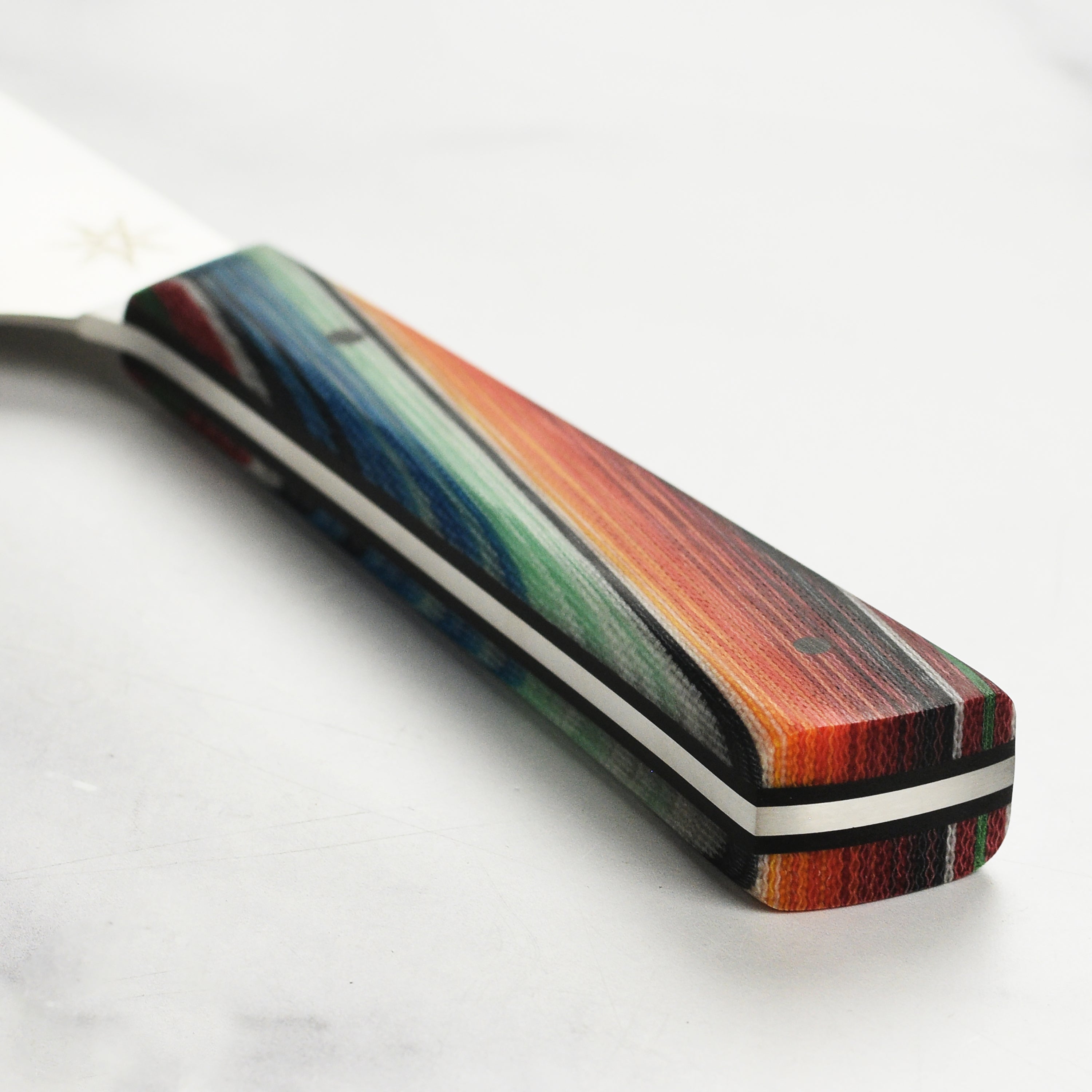 Close-up of the handmade Baja Pro chefs knife, highlighting the unique Mexican blanket especial G-Carta handle.