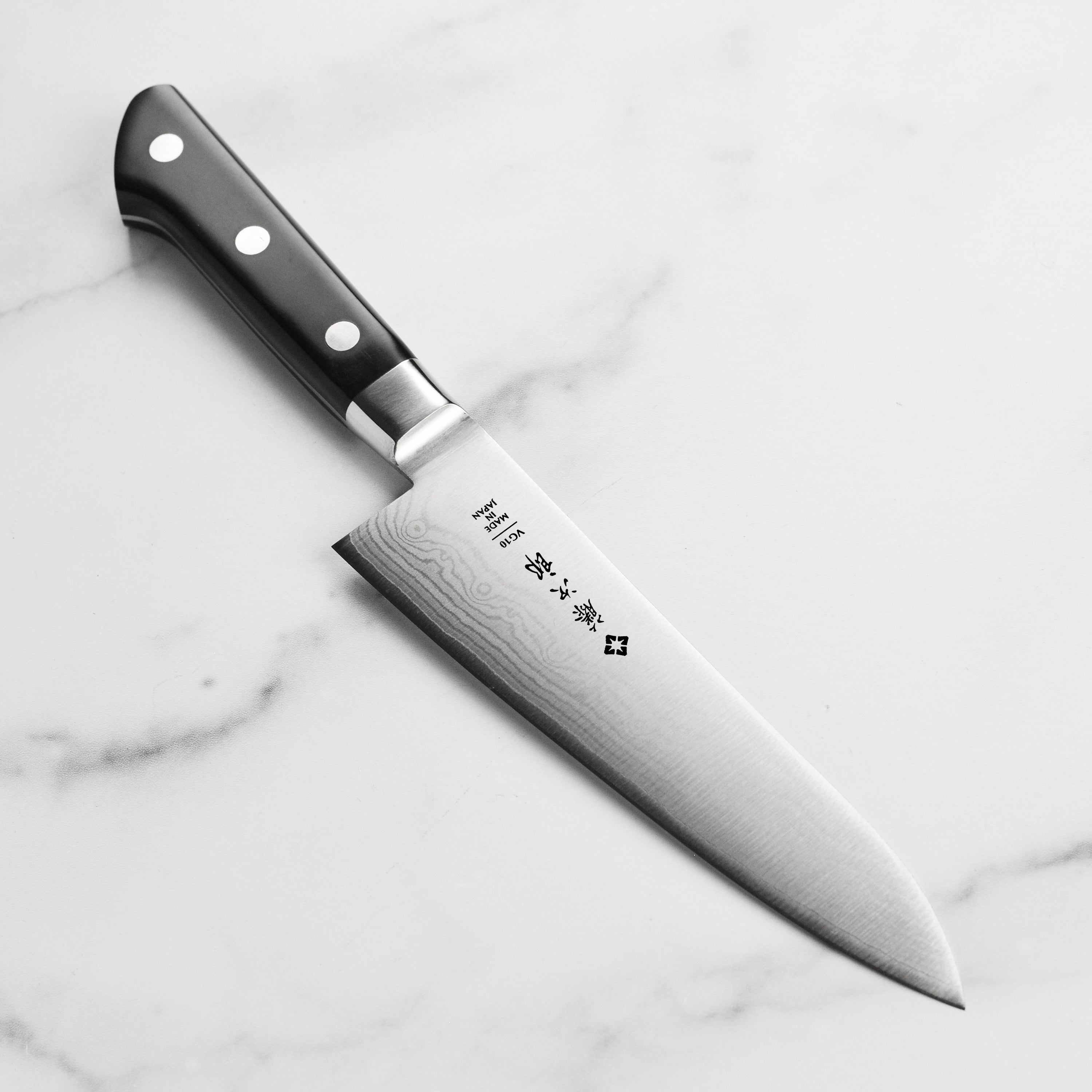 Tojiro Damascus 7-inch chef's knife blade showing layered damascus pattern