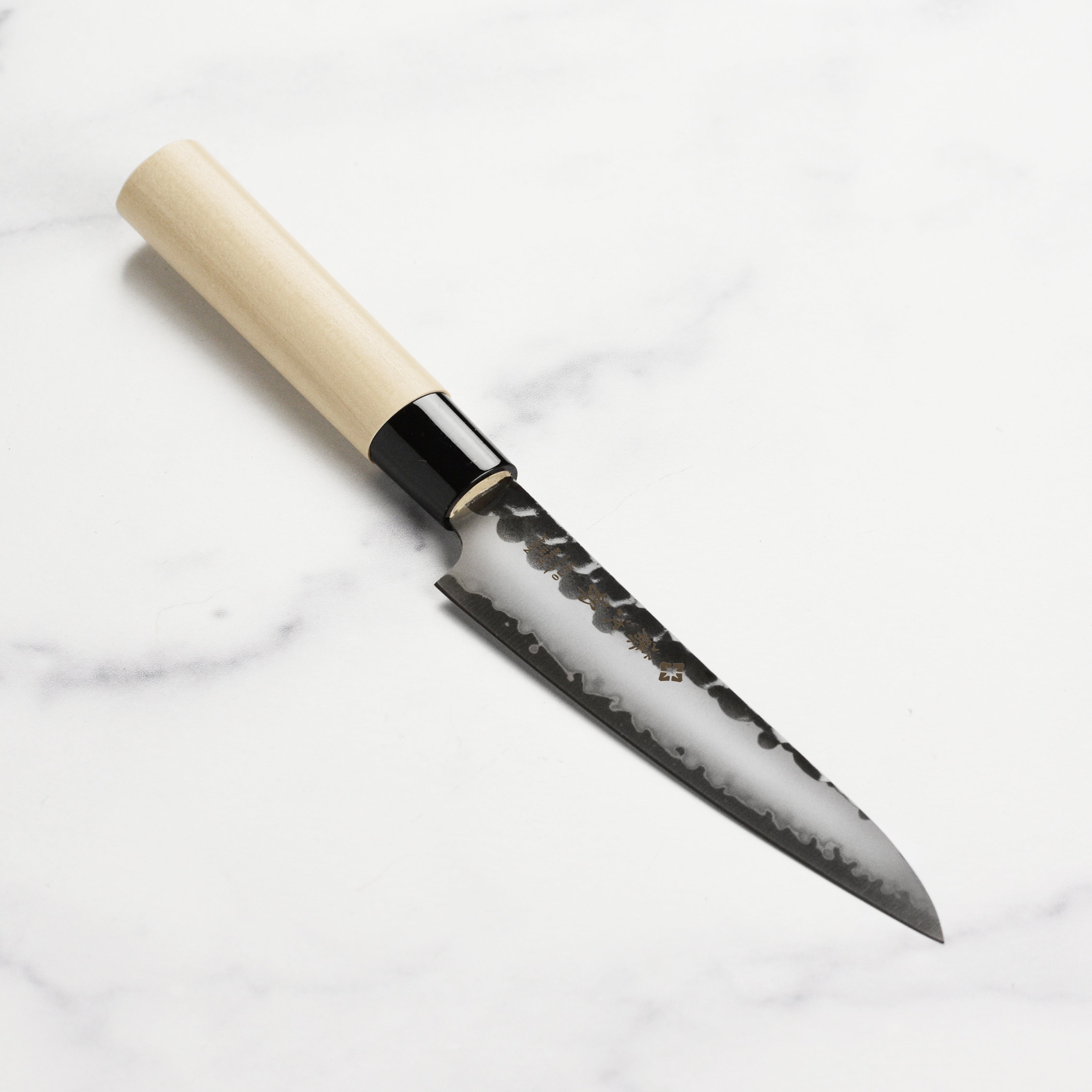 Tojiro Hammered Petty Knife 5-inch showcasing the hammered texture and Kurouchi finish, perfect for precision cutting.