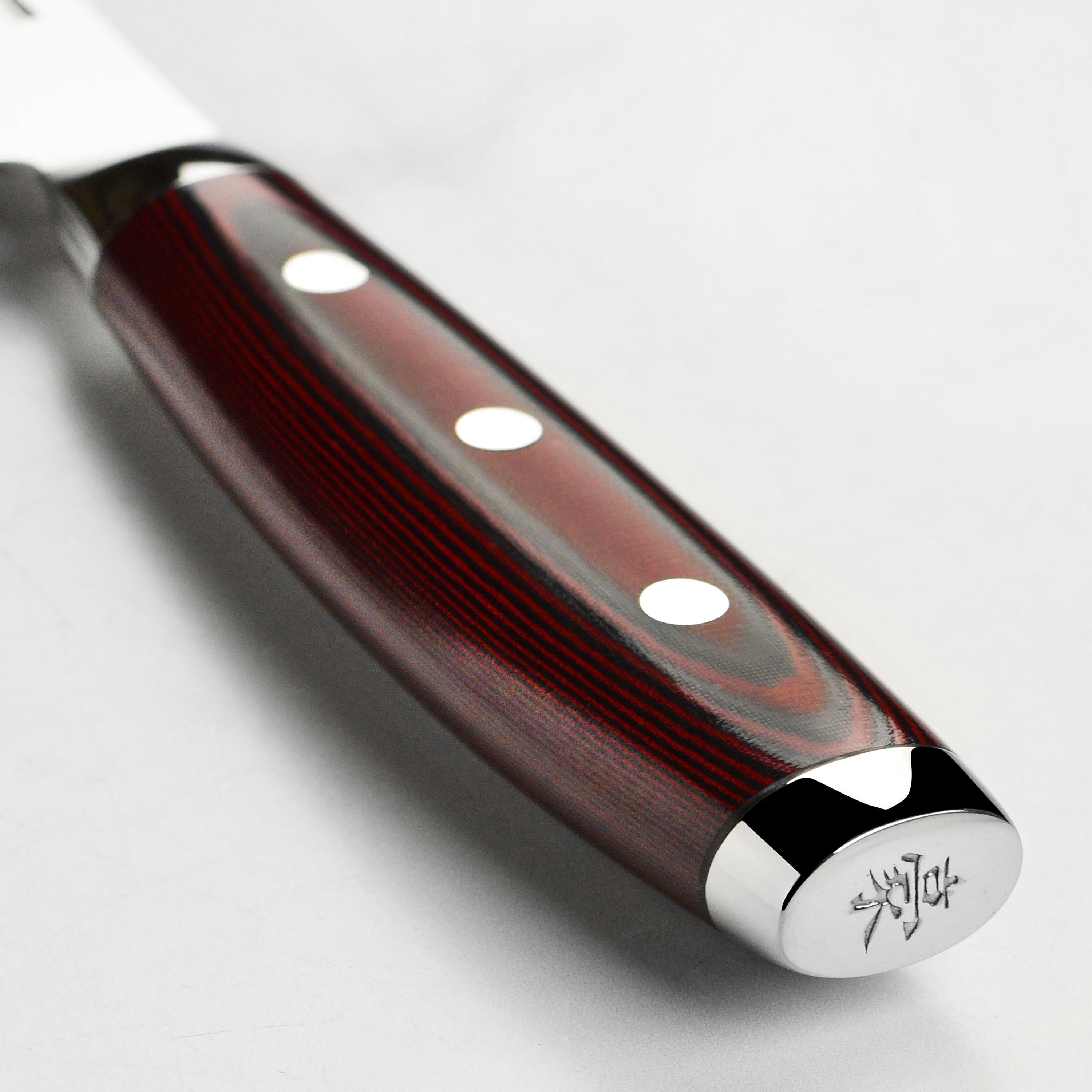 Professional chef using Yaxell SG2 9.5-inch knife for precise slicing
