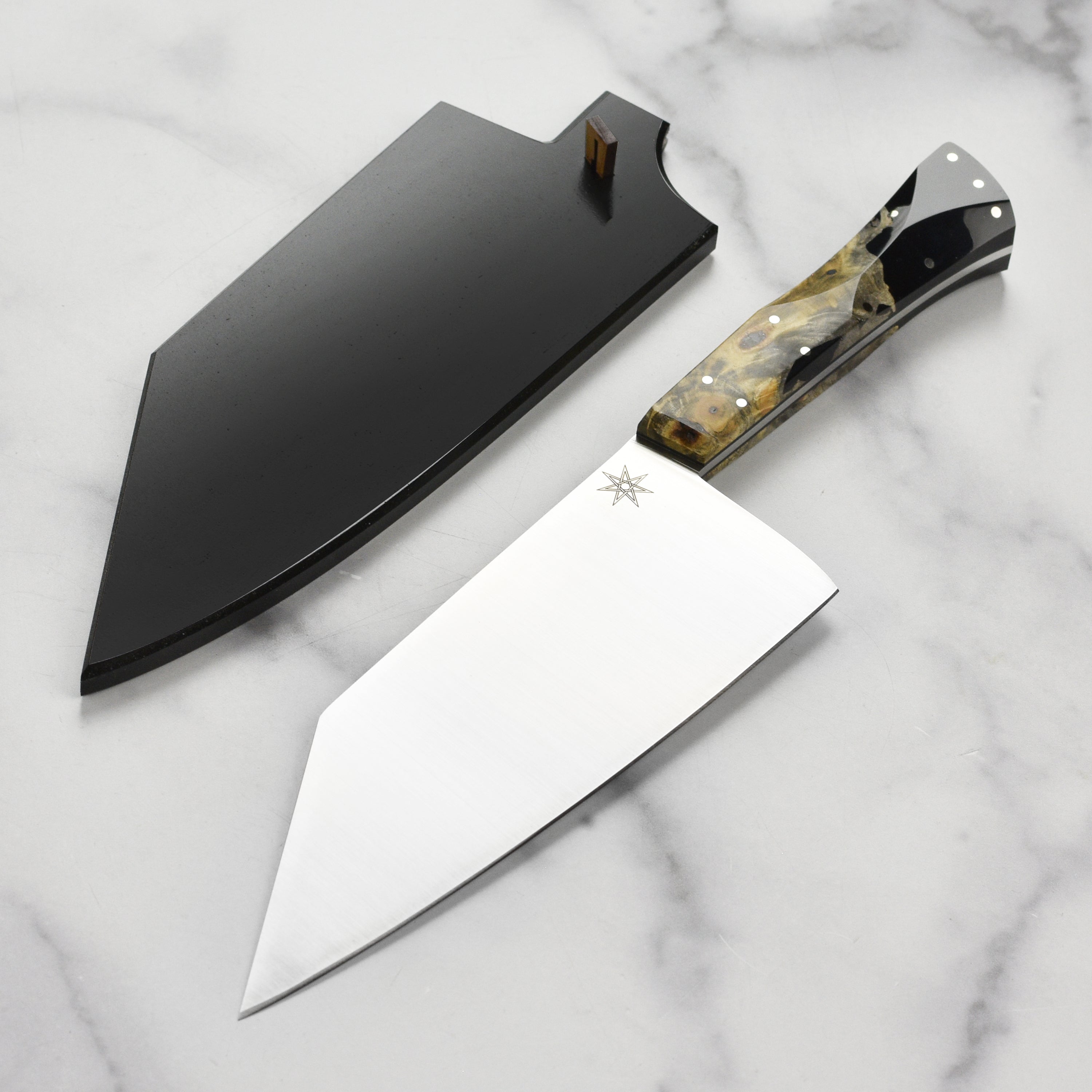 Desert Dawn chef knife with live-edge buckeye burl handle and stainless steel blade from an angle.