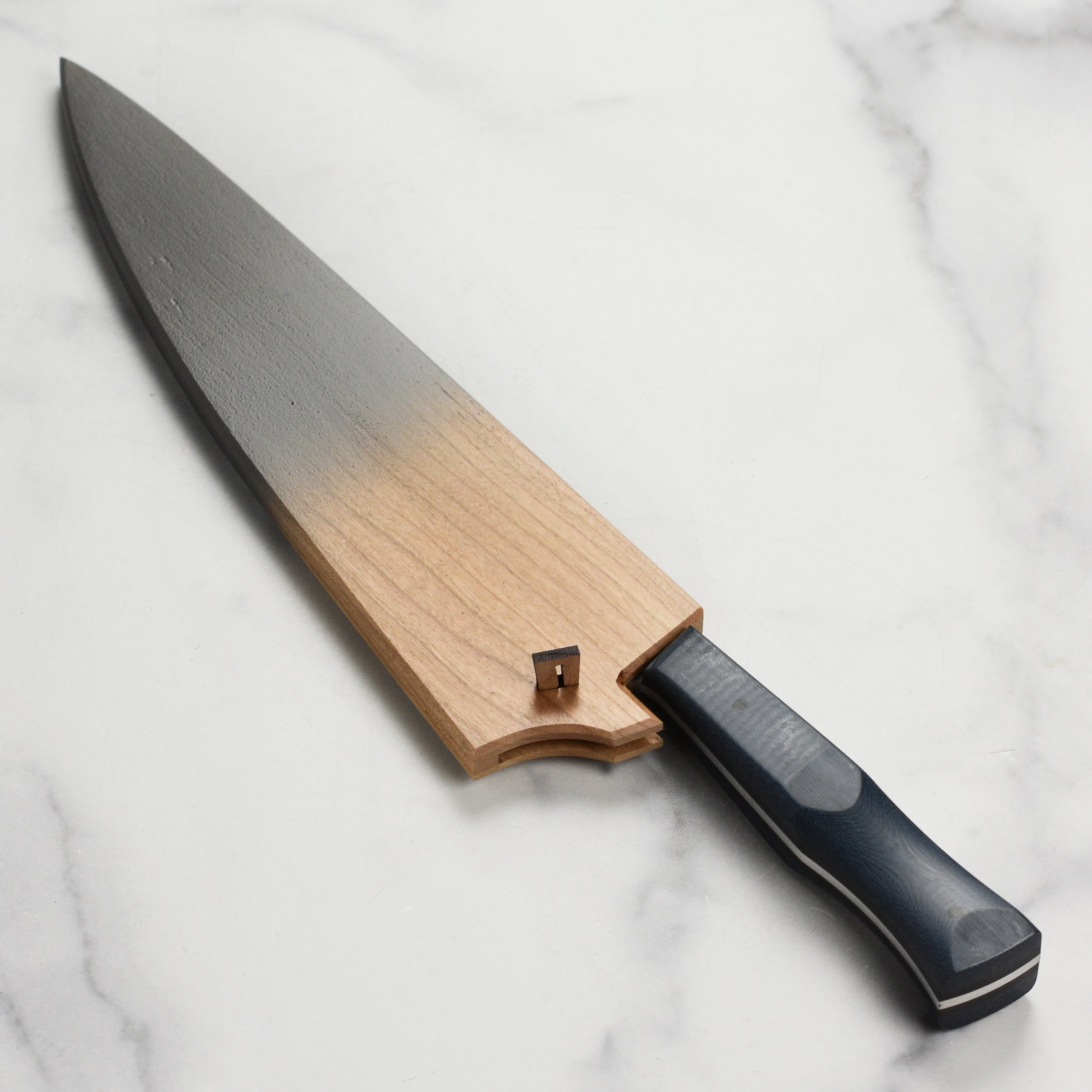 Side view of Town Cutler eXo Blue knife saya showcasing cherry wood design.
