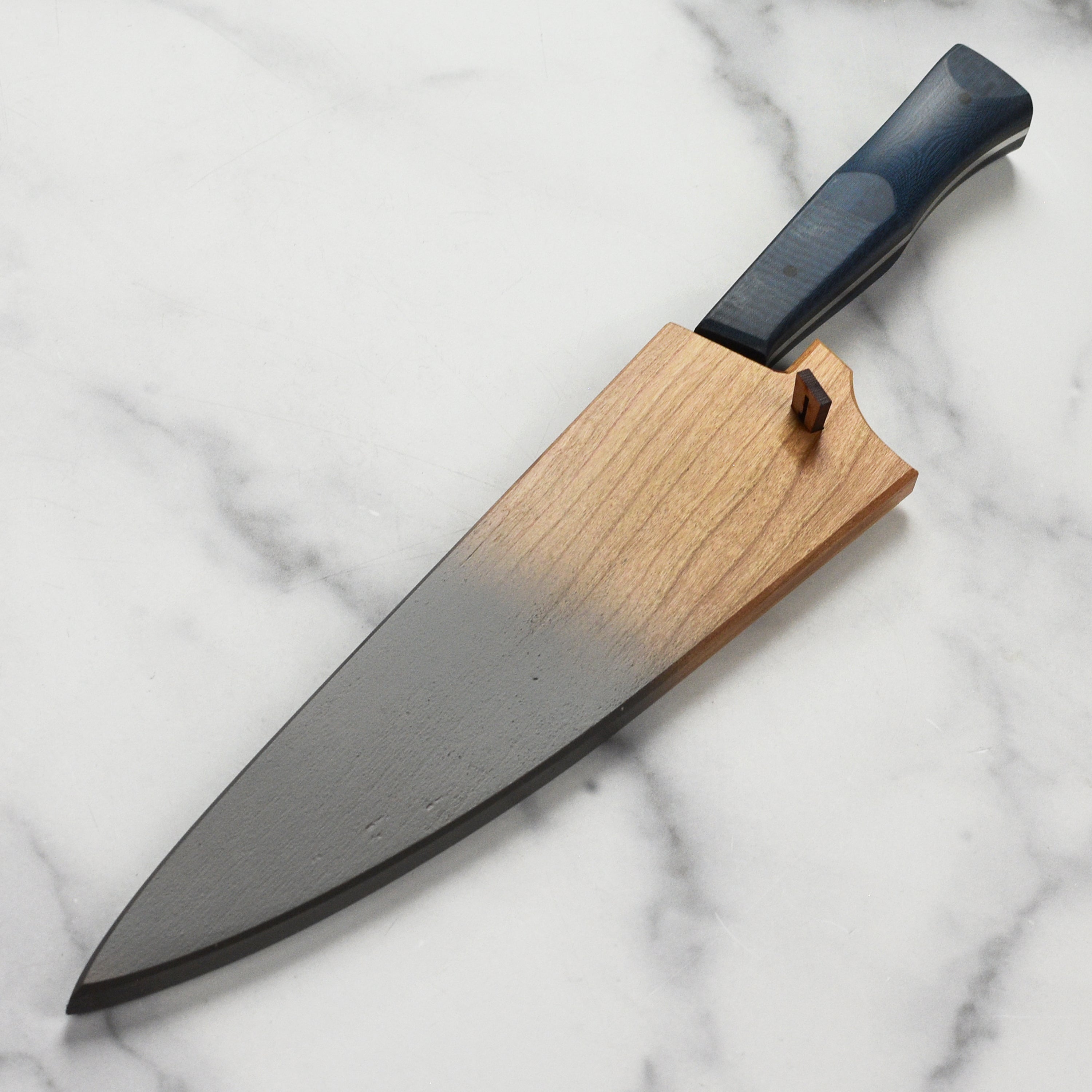 Town Cutler eXo Blue chef knife saya in use during meal preparation.