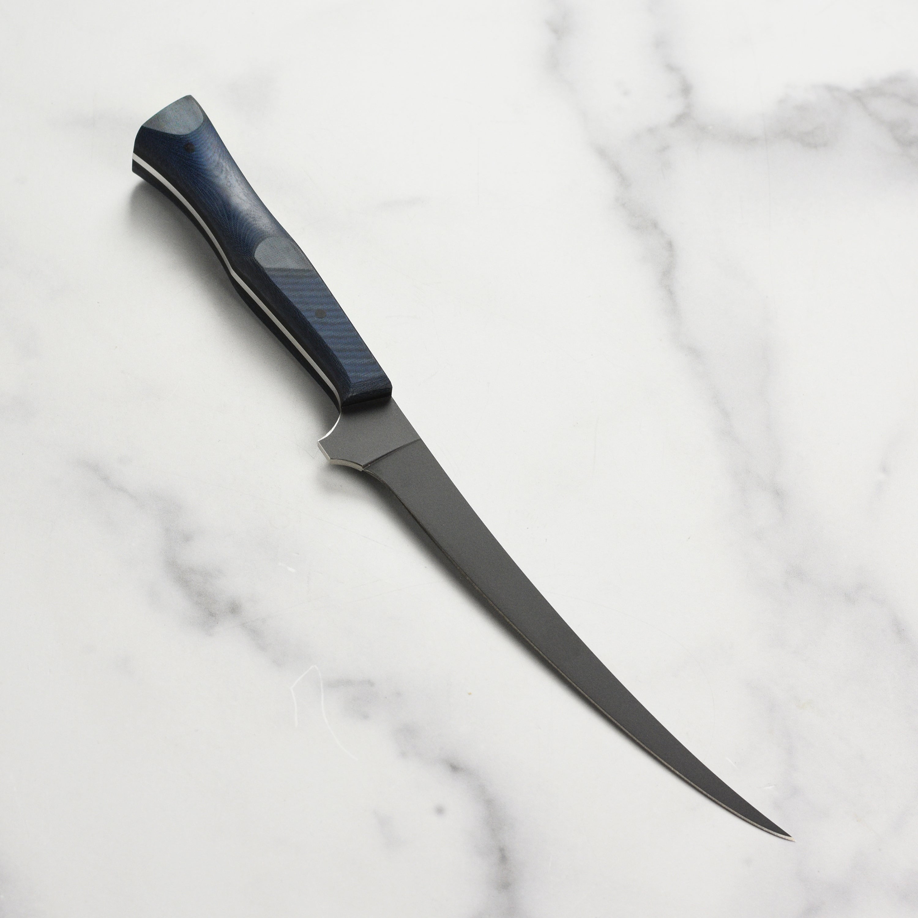 Detailed shot of the Nitro-V stainless steel blade with Cerakote finish and blue Micarta handle