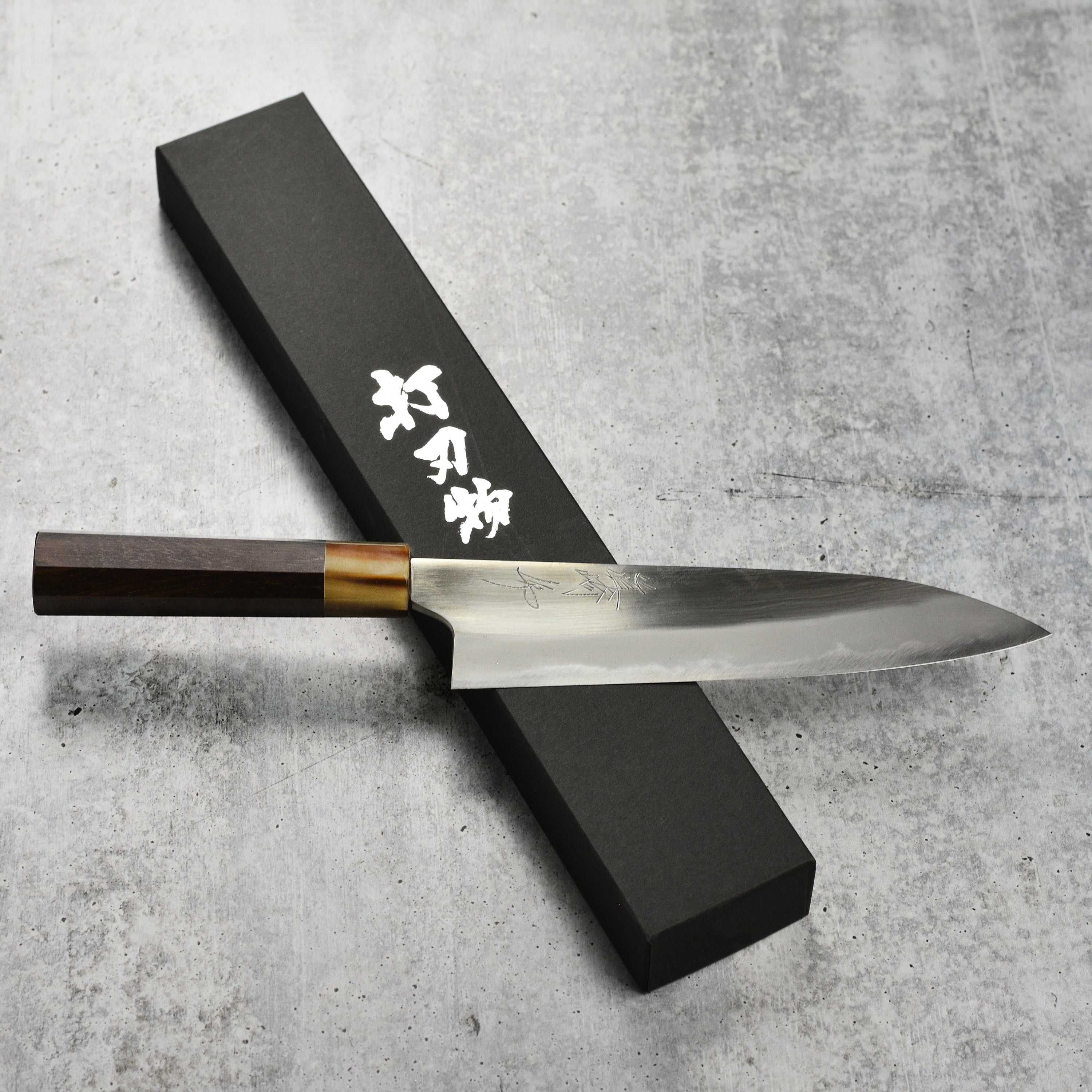 Mazaki Shirogami Gyuto 8.25" chef knife with wooden handle, angled view