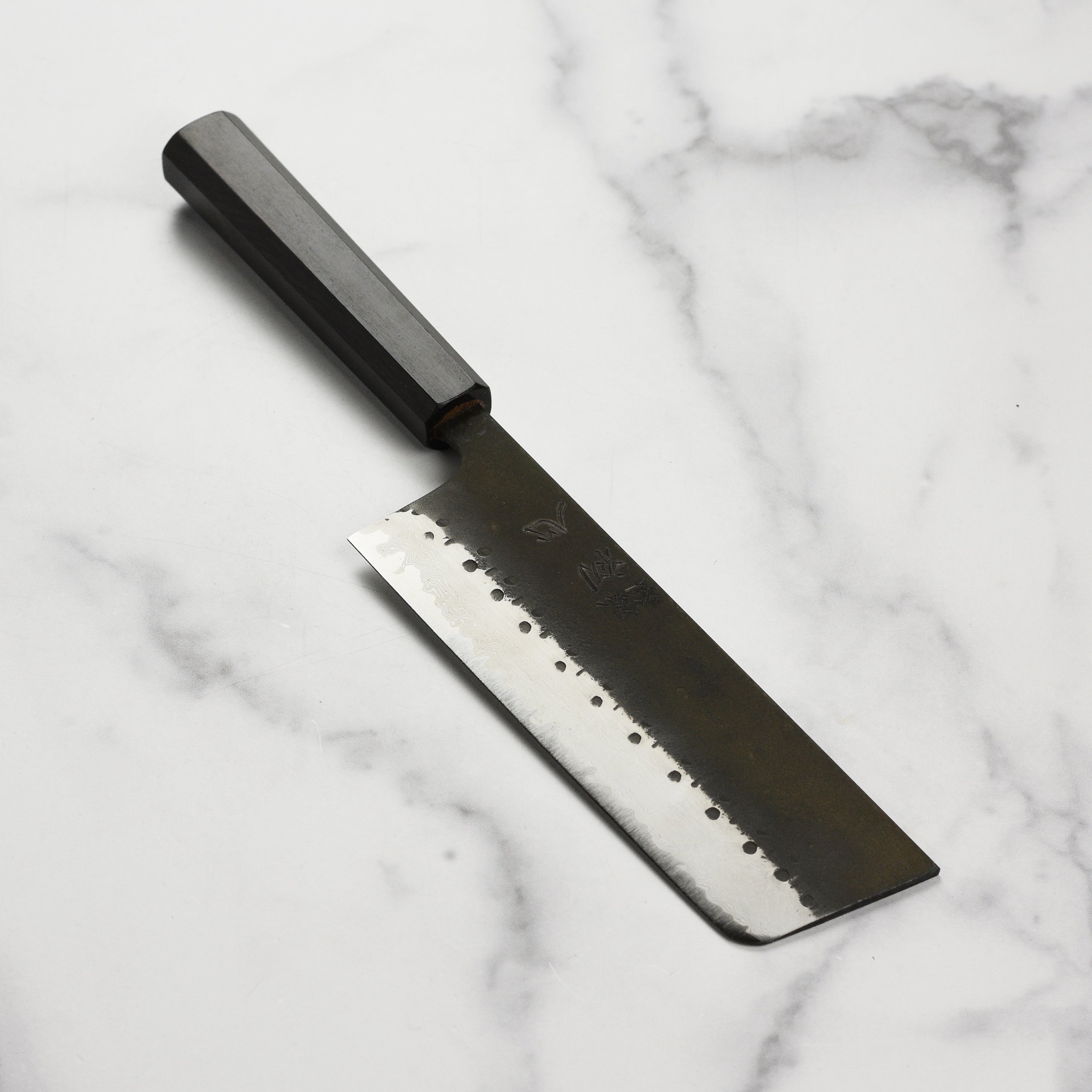 Hatsukokoro Damascus nakiri knife on cutting board for vegetable prep