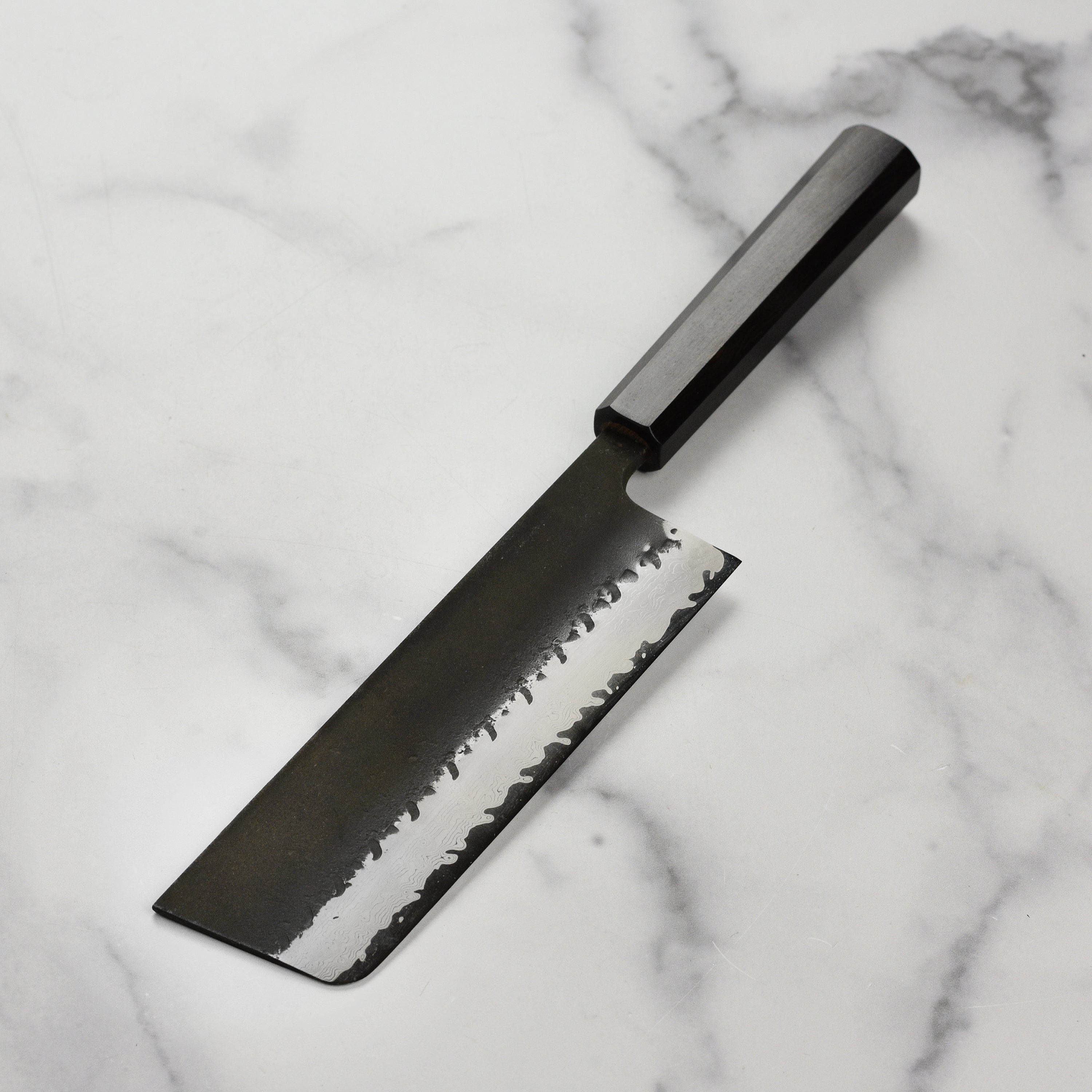 Close-up of the Kurouchi finish on the Japanese knife blade