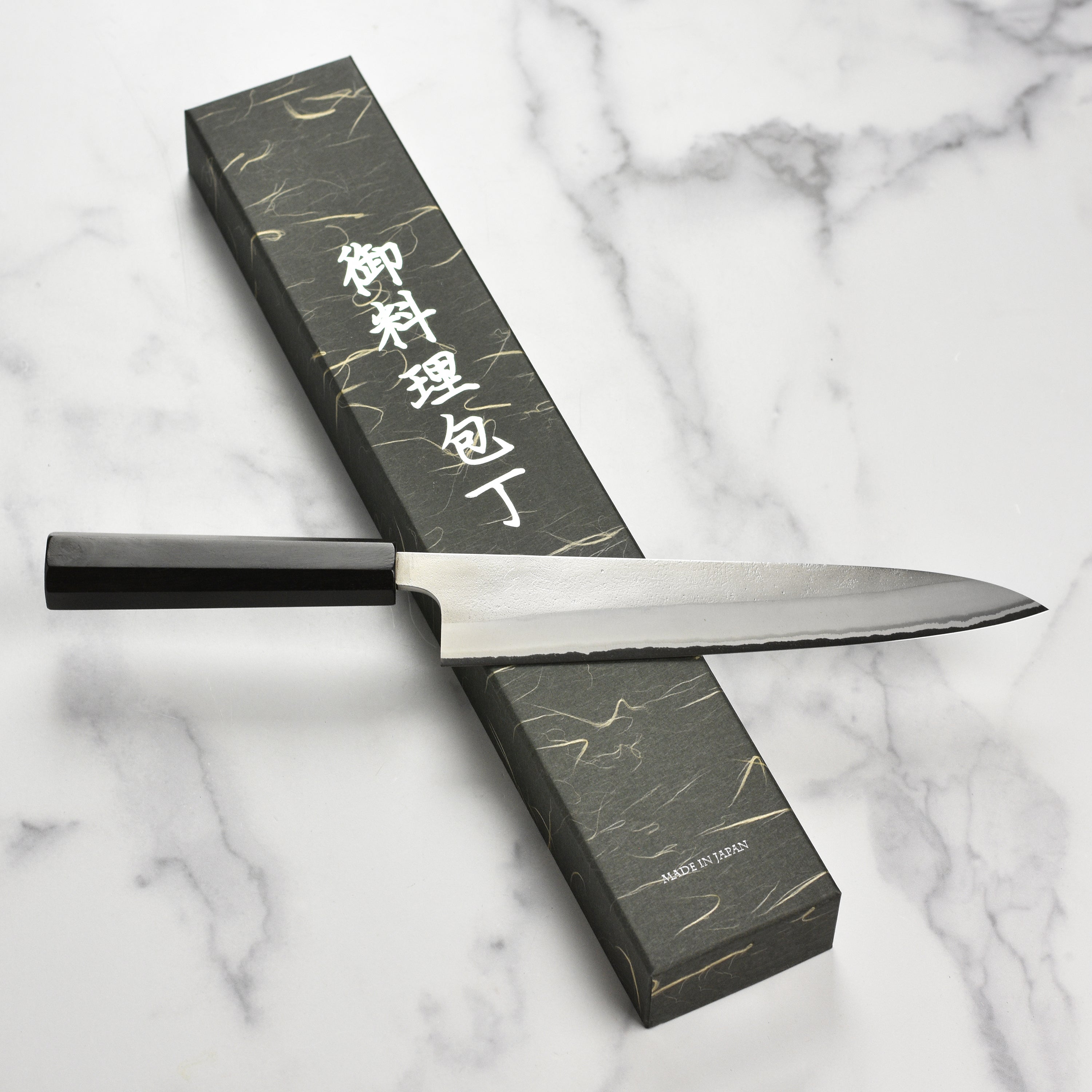 Elegant Japanese chef knife with Nashiji finish, highlighting craftsmanship