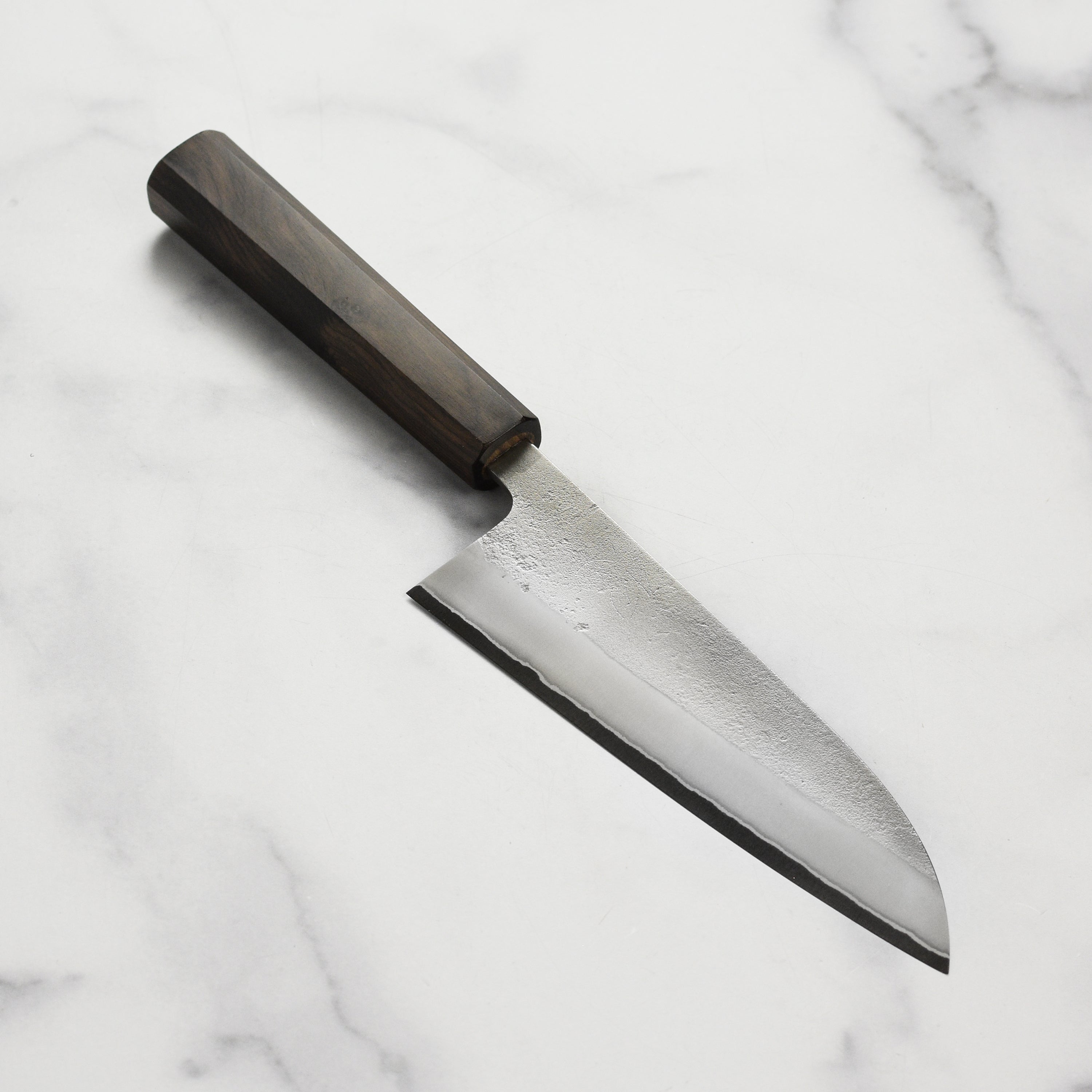 Yoshikane Shirogami Santoku knife blade close-up showing sharp cutting edge