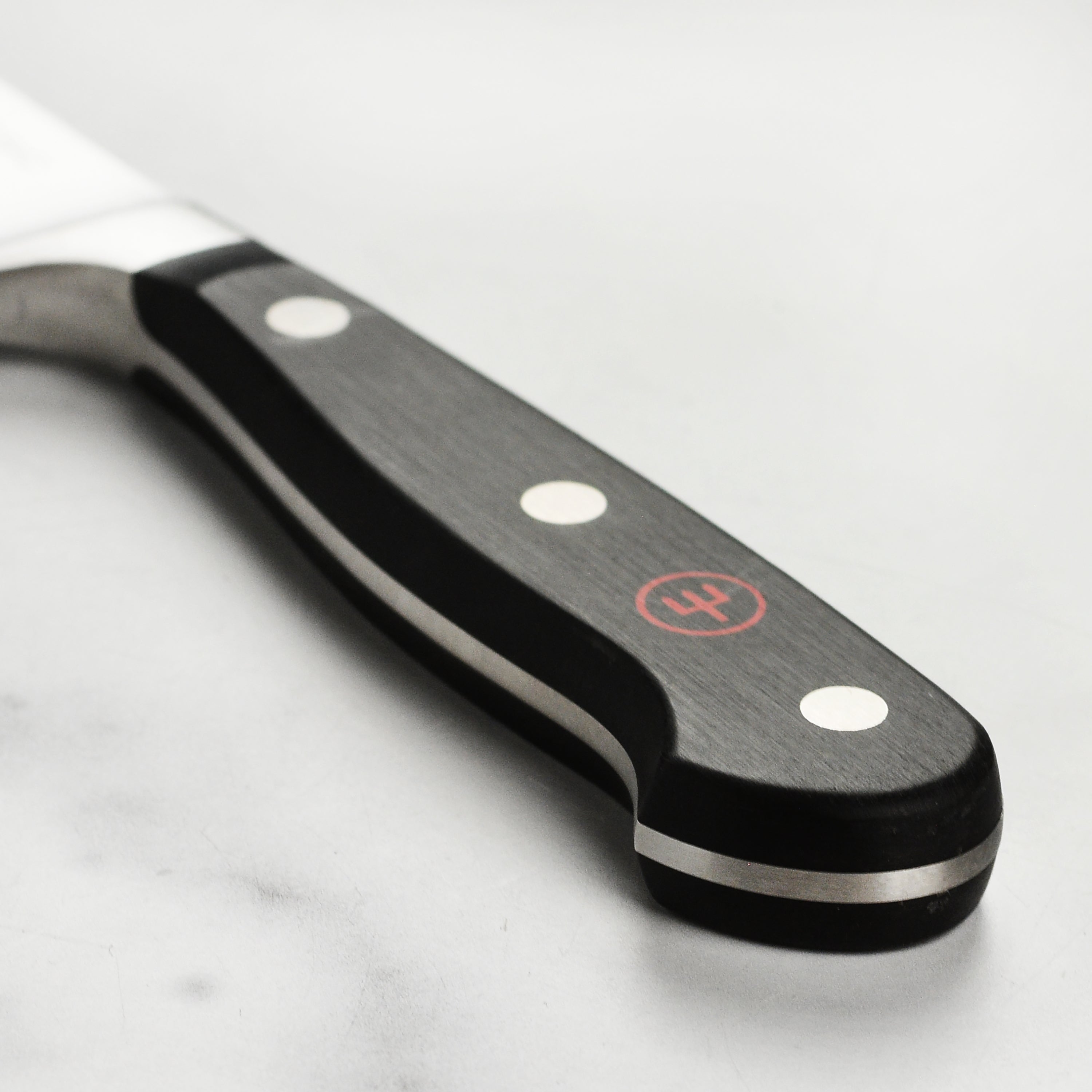 Chef slicing vegetables with the Wusthof classic 5-inch knife in a modern kitchen