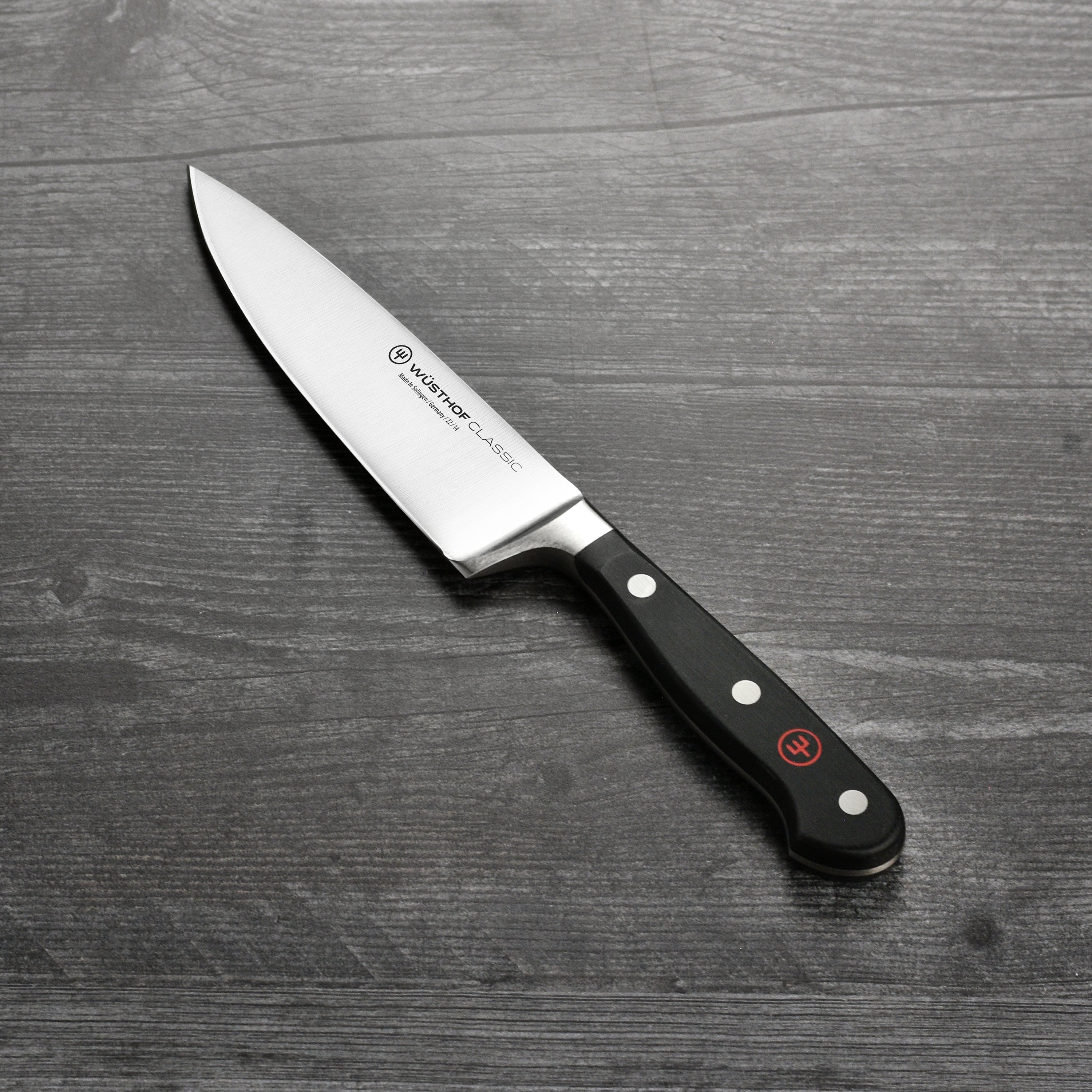 Chef slicing vegetables with the Wusthof classic 5-inch knife in a modern kitchen