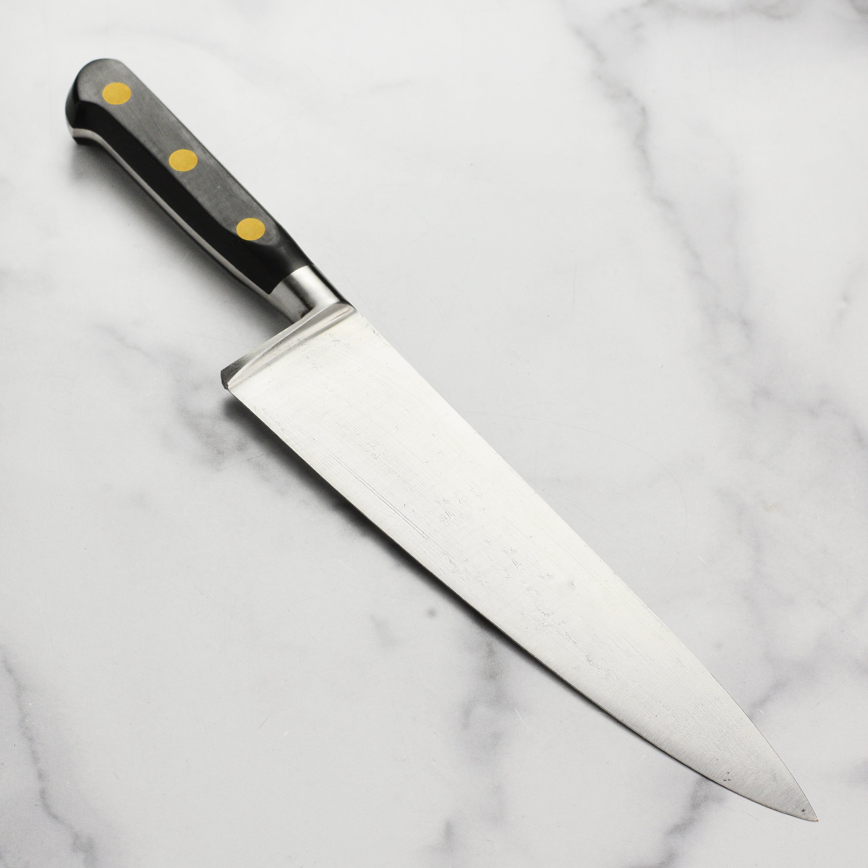 Full view of the K Sabatier Au Carbone 9 inch chefs knife showcasing its elegant French style bolster