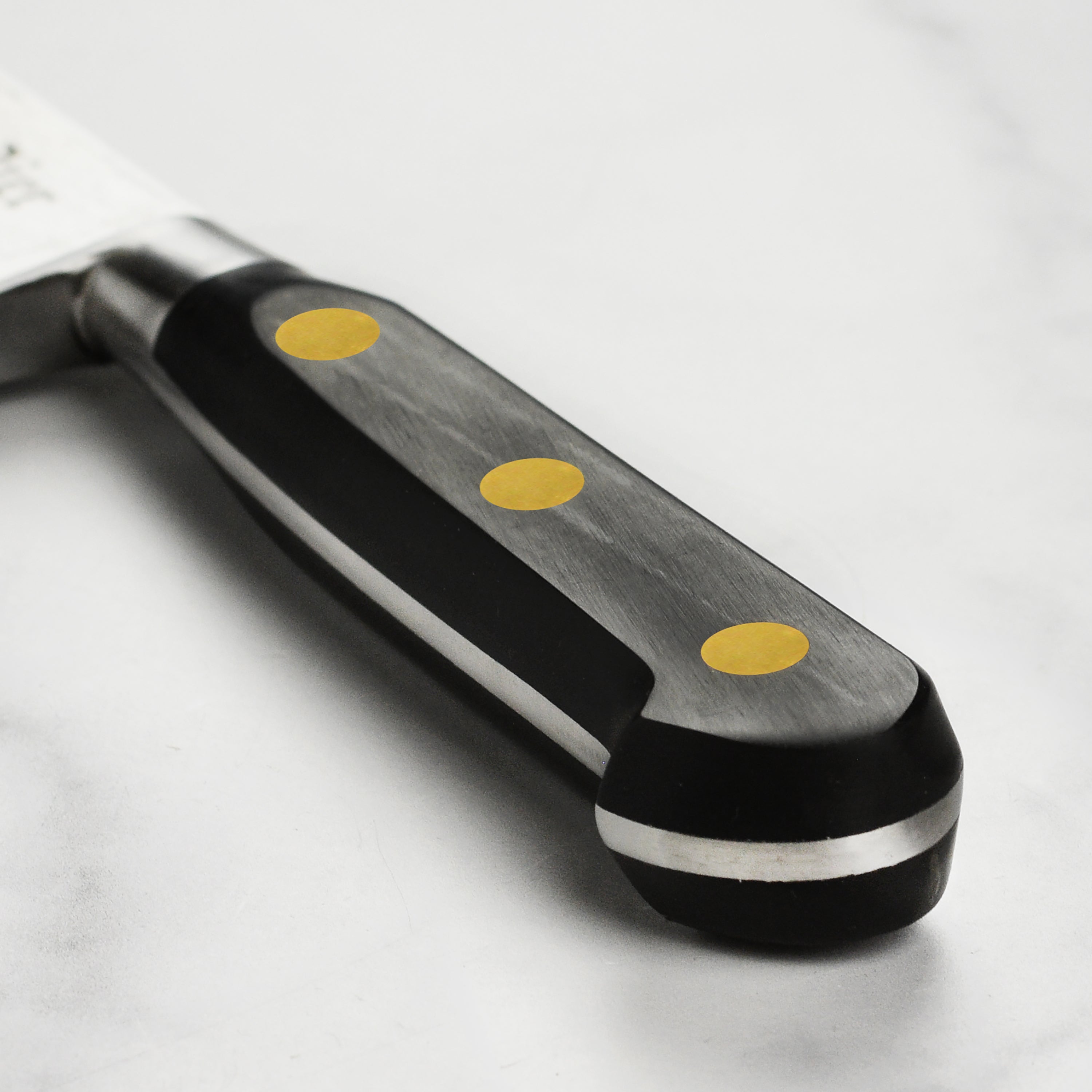 Chef using the K Sabatier 9 inch chefs knife on a cutting board, highlighting its precision edge