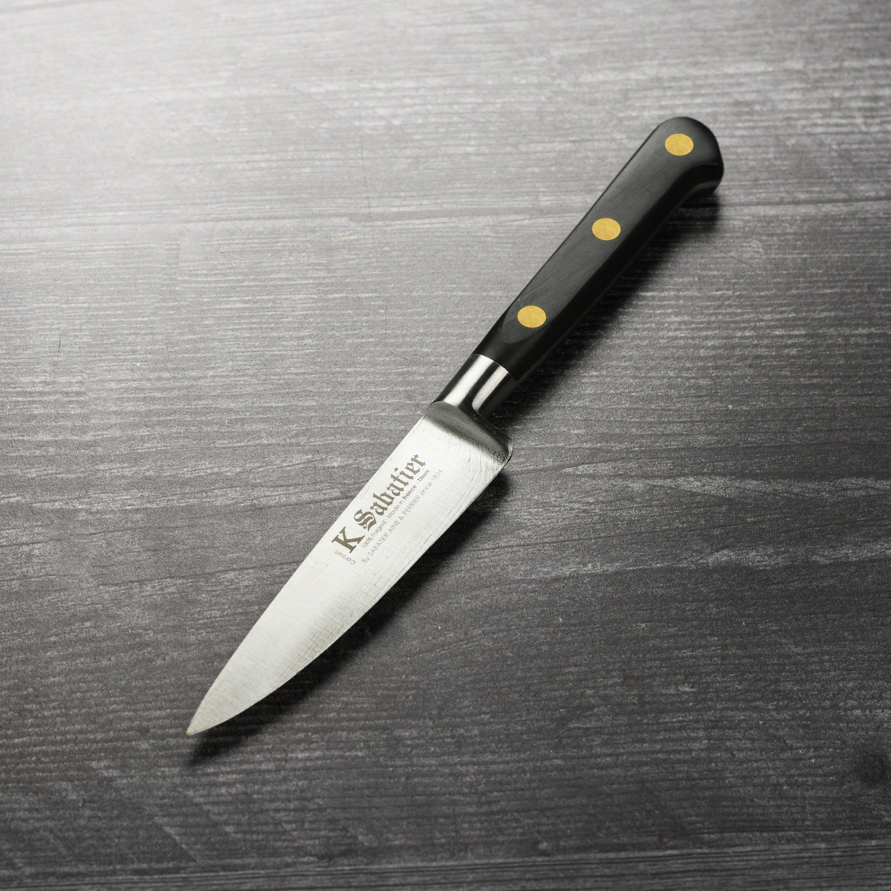 Sabatier Au Carbone 4-inch French paring knife blade close-up showing carbon steel craftsmanship