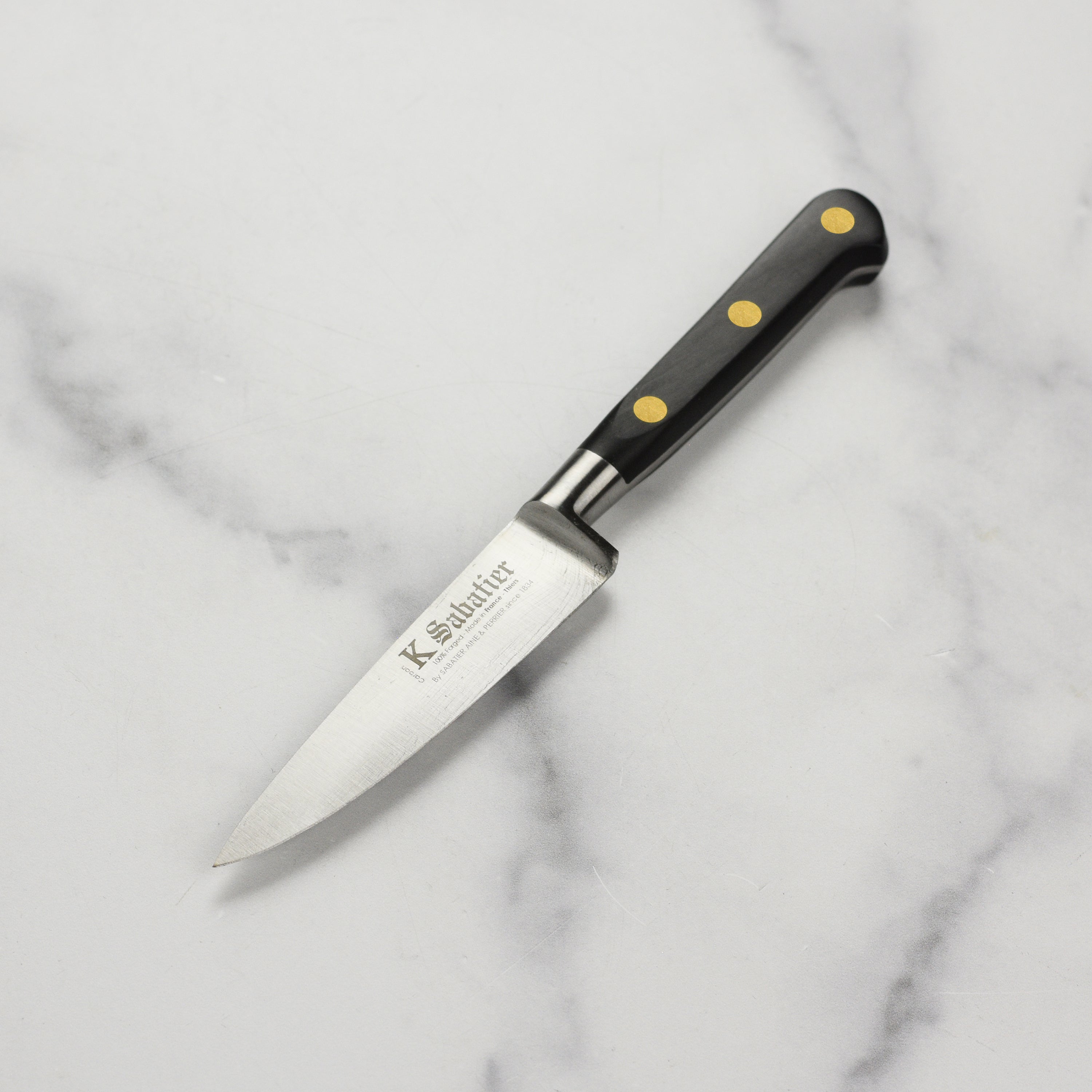 Sabatier Au Carbone 4-inch French paring knife blade close-up showing carbon steel craftsmanship