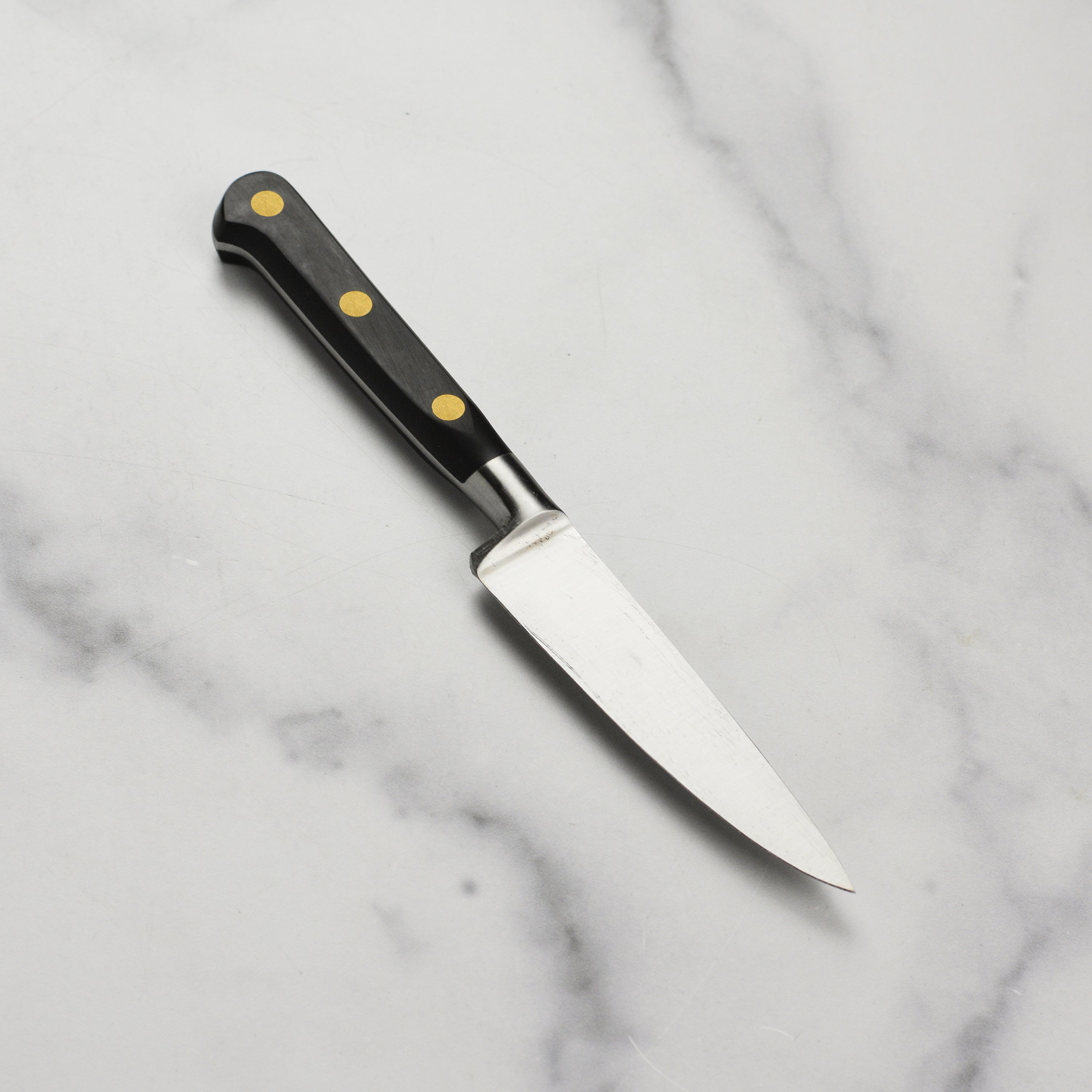 Professional-grade carbon steel knife in a kitchen setting, perfect for precision tasks