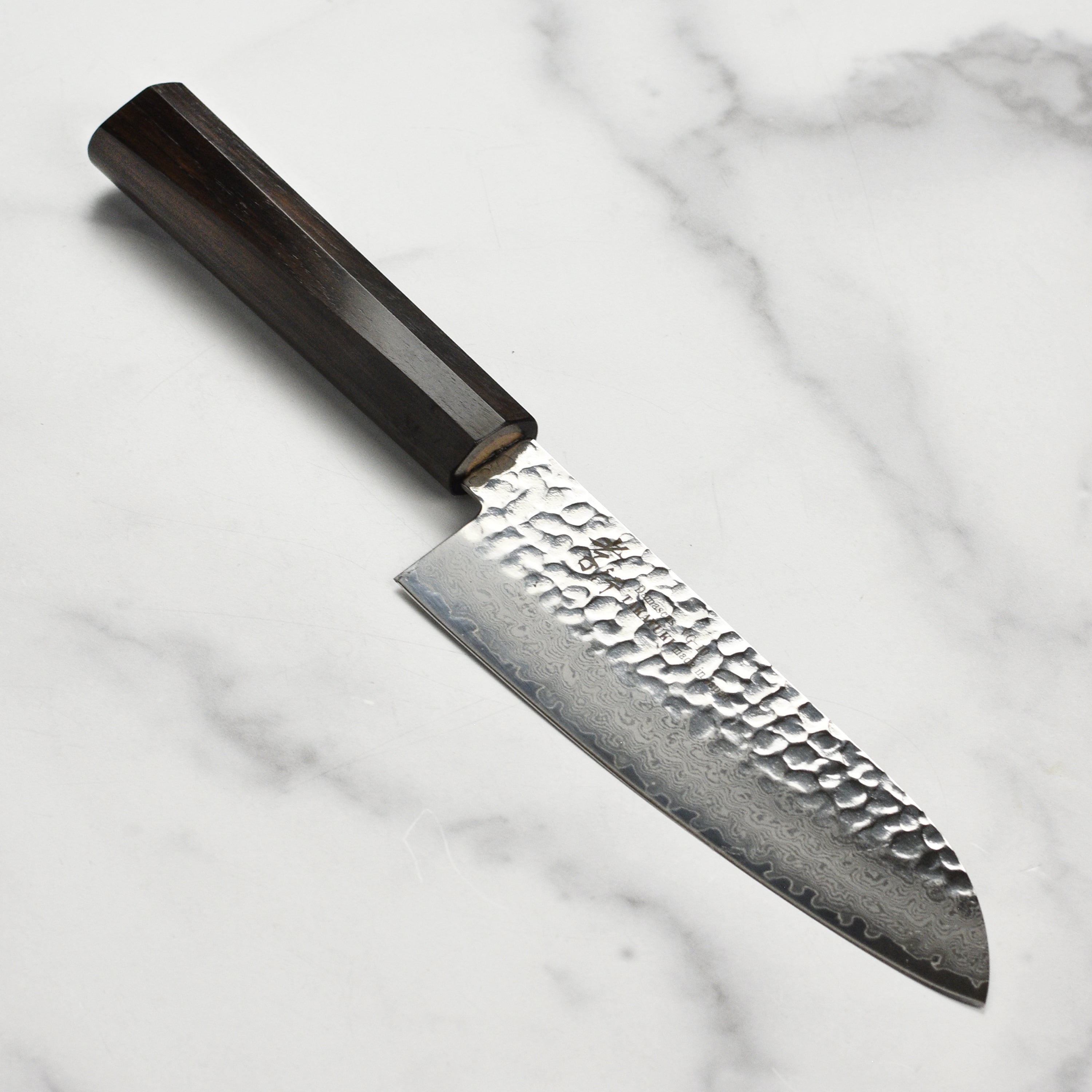 Close-up of the premium Damascus Santoku knife showcasing the intricate blade design.