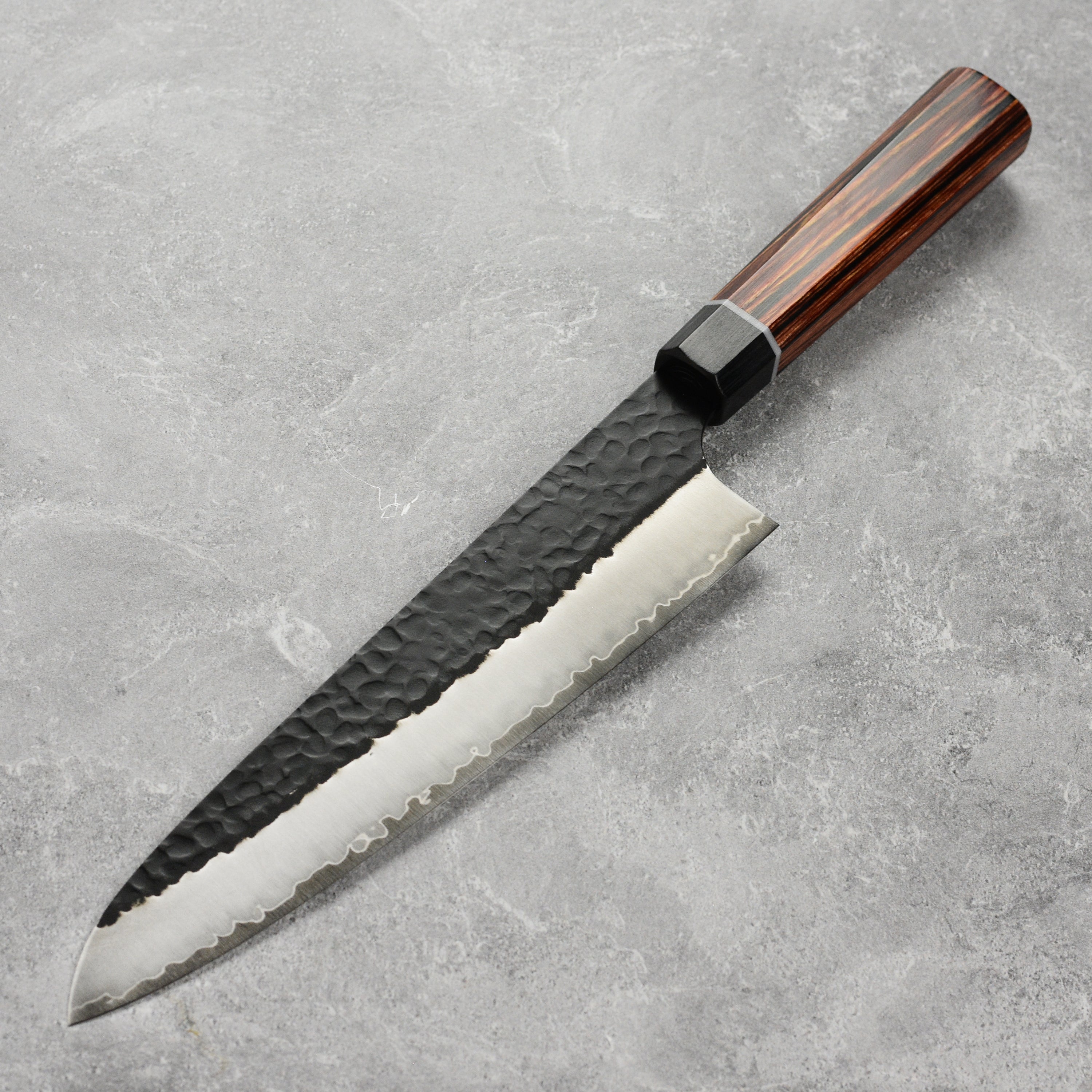 Close-up of the razor-sharp edge of the Japanese chef knife for precise slicing
