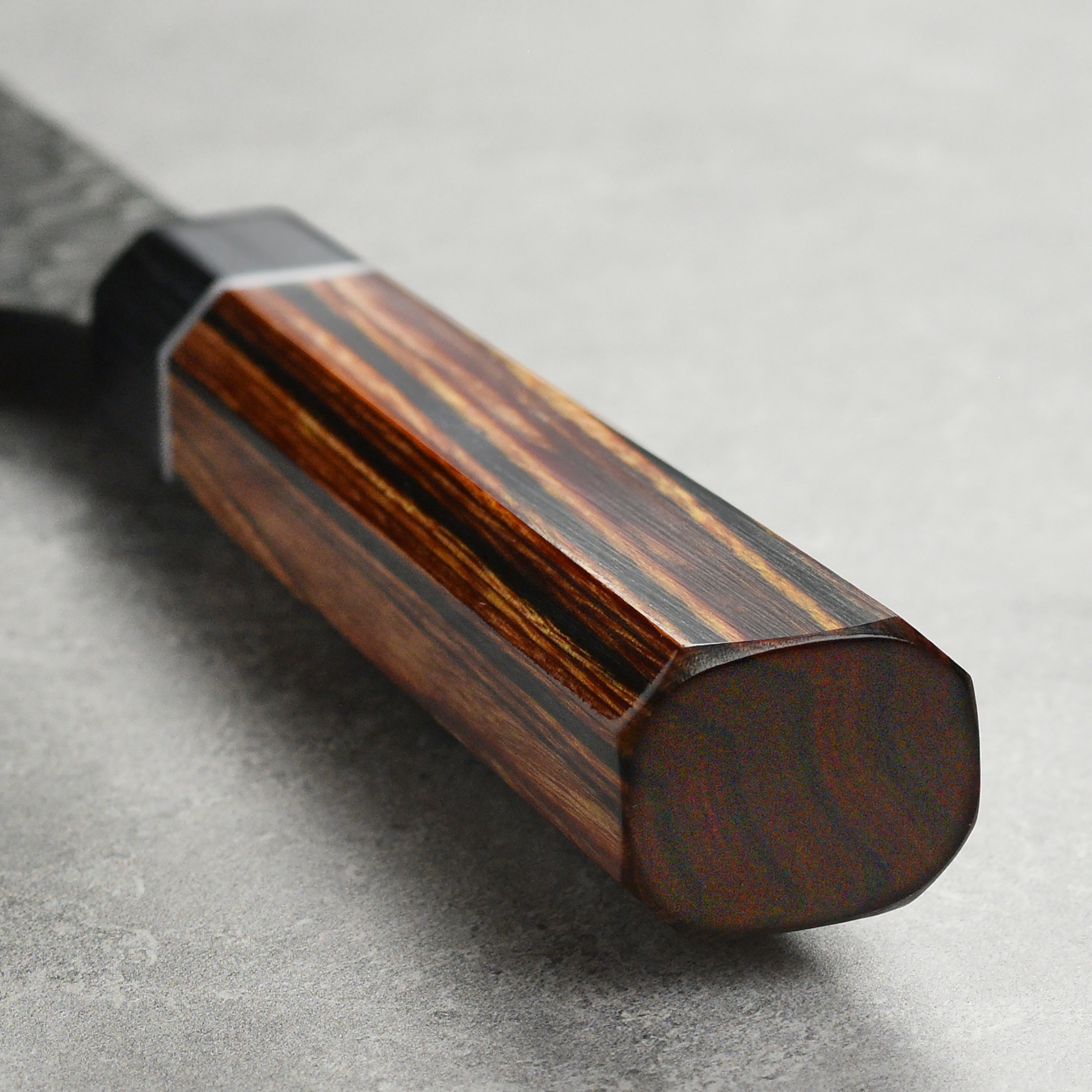 Enso Hachi SG2 Bunka Knife in action, slicing vegetables on a wooden cutting board.