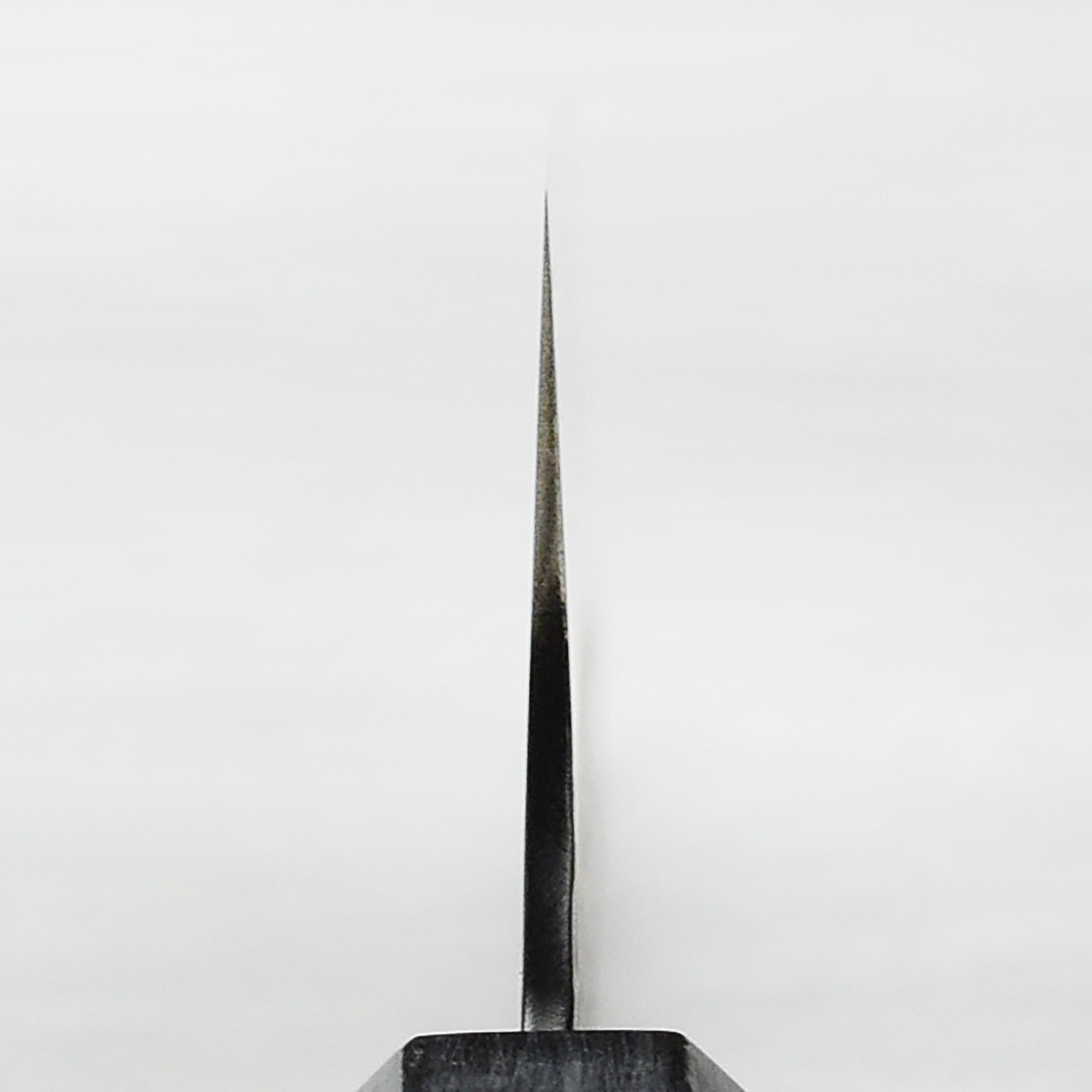 Ergonomic octagonal pakkawood handle of the SG2 Gyuto for a secure grip