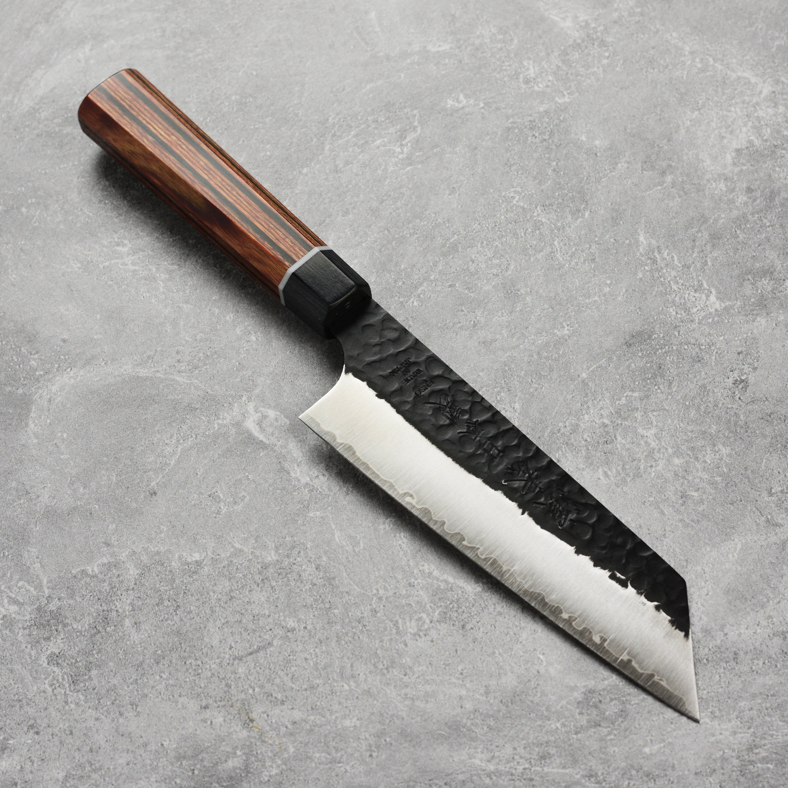 Close-up of the Enso Hachi SG2 Bunka Knife blade highlighting its hammered texture and sharp edge.