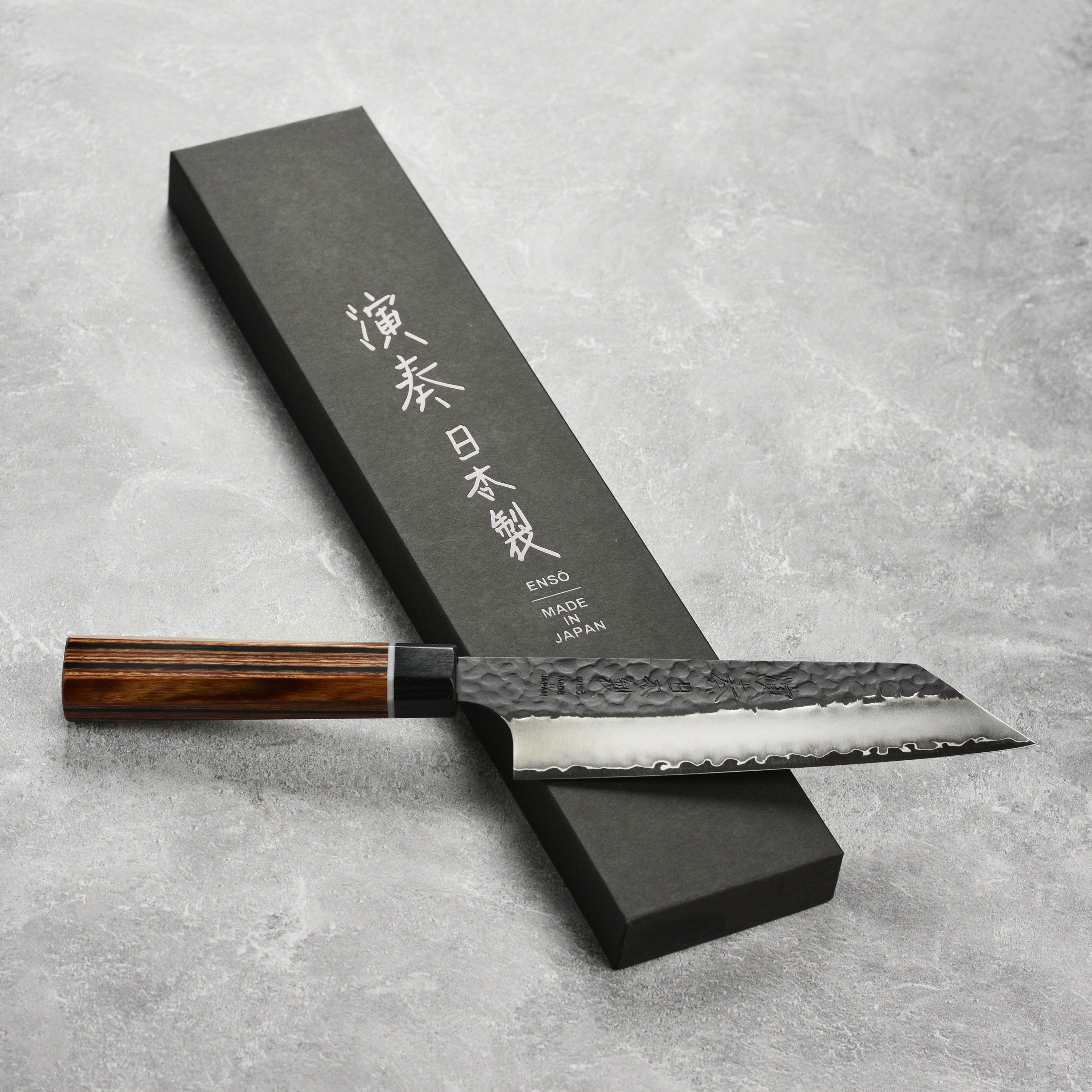 Enso Hachi SG2 Bunka Knife in action, slicing vegetables on a wooden cutting board.