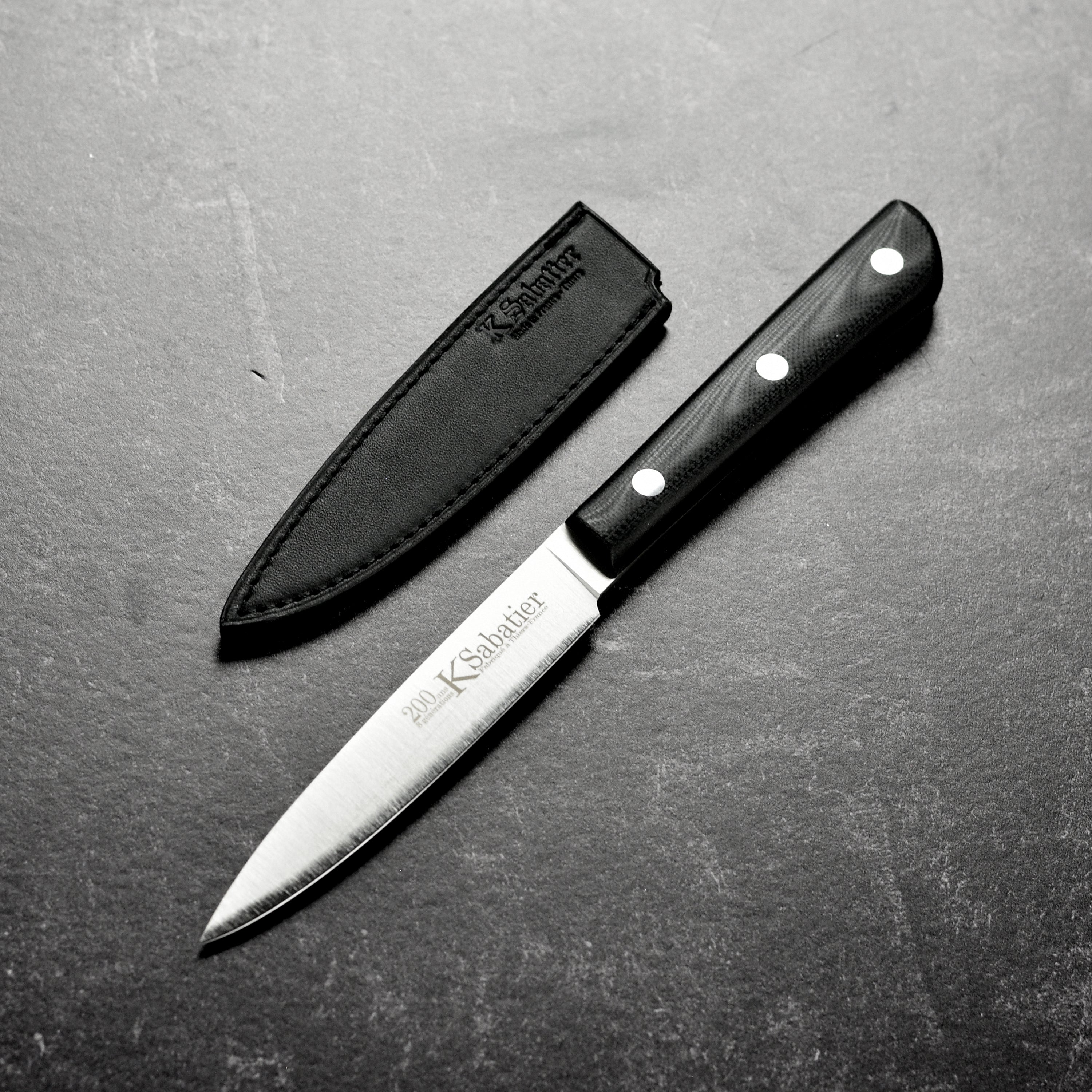 Sabatier 200th Anniversary stainless steel paring knife on a cutting board