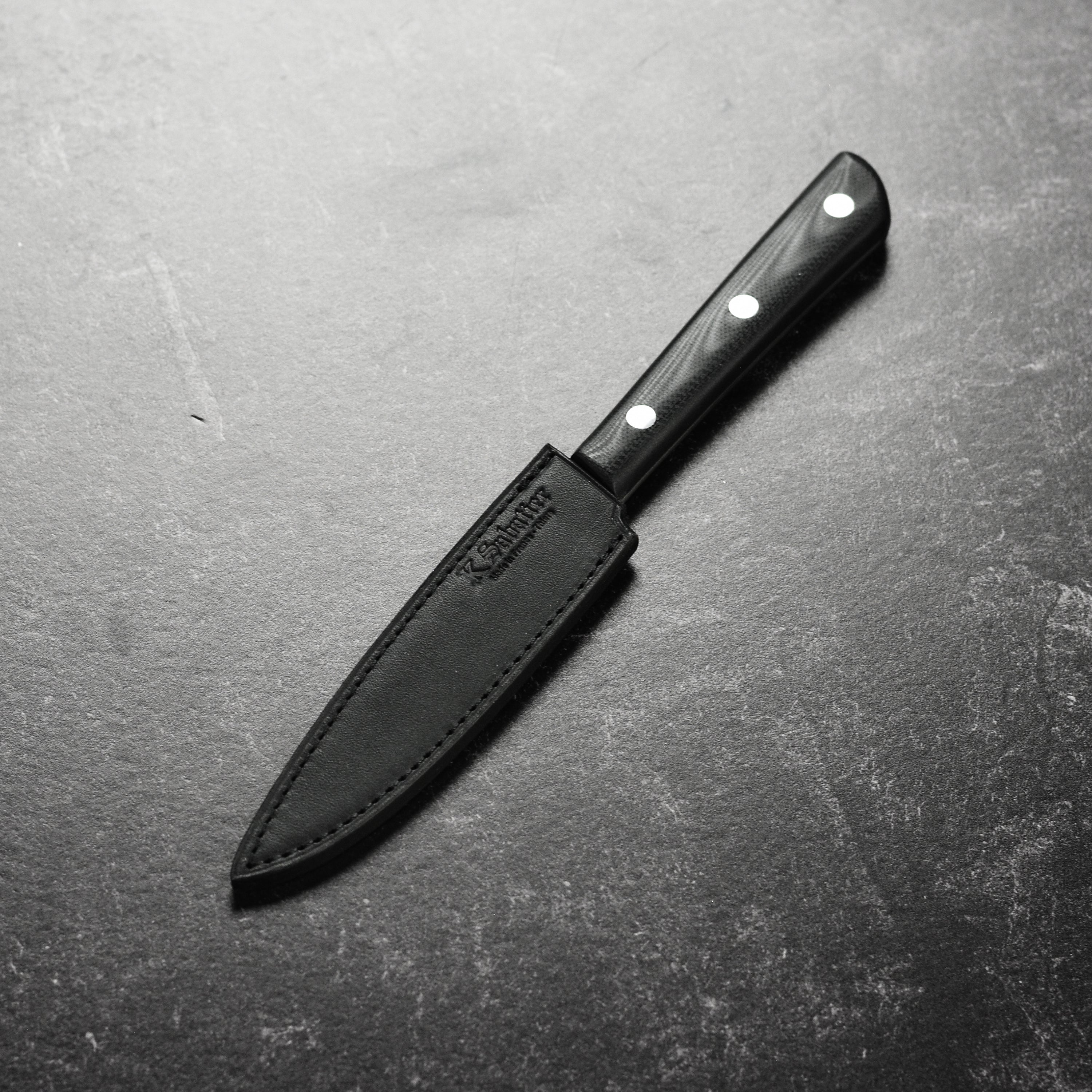 Sabatier 200th Anniversary stainless steel paring knife on a cutting board