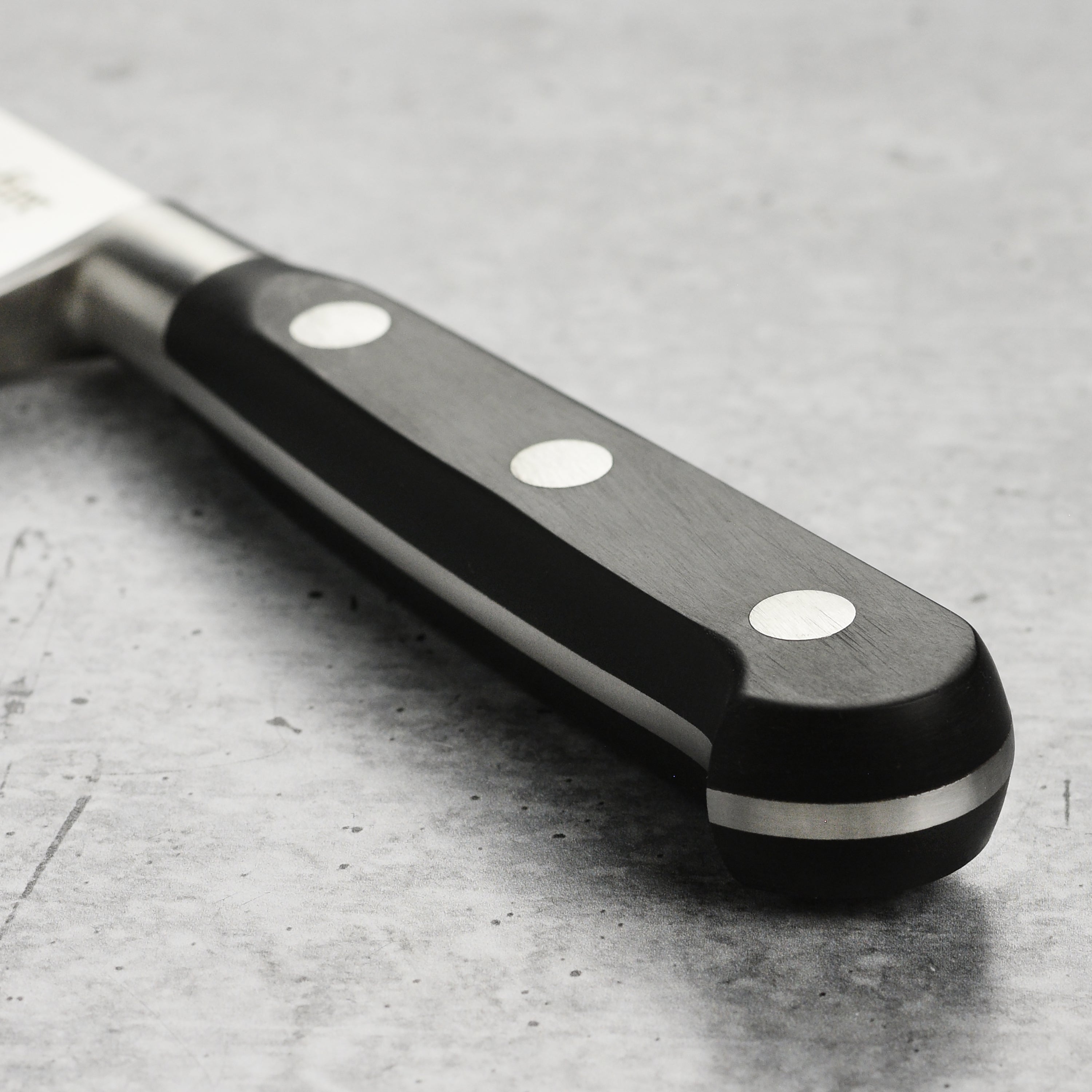 Professional chef using K Sabatier Authentique 1834 Chefs Knife in a kitchen setting.