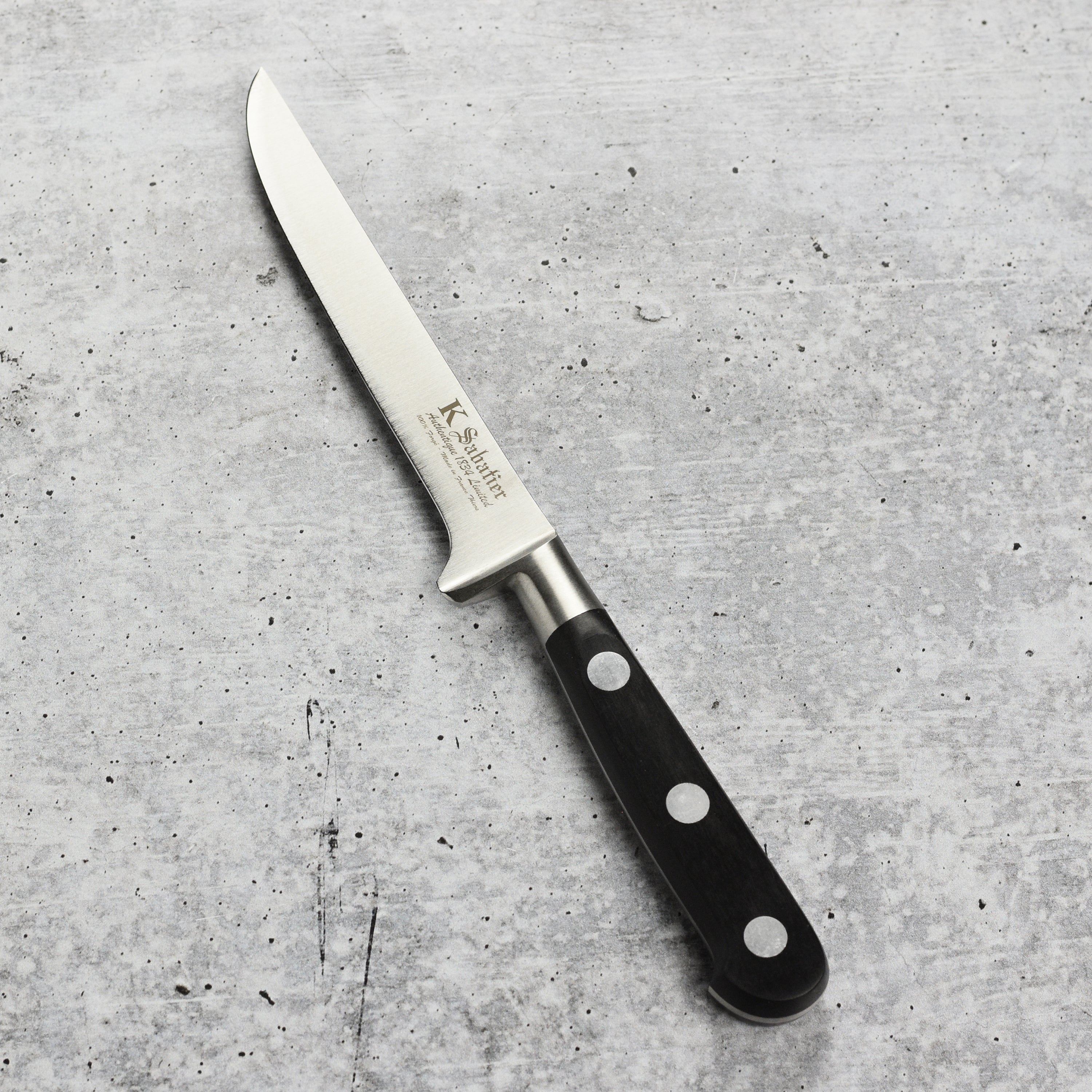 Side view of the kitchen knife with ergonomic POM handle and classic French bolster
