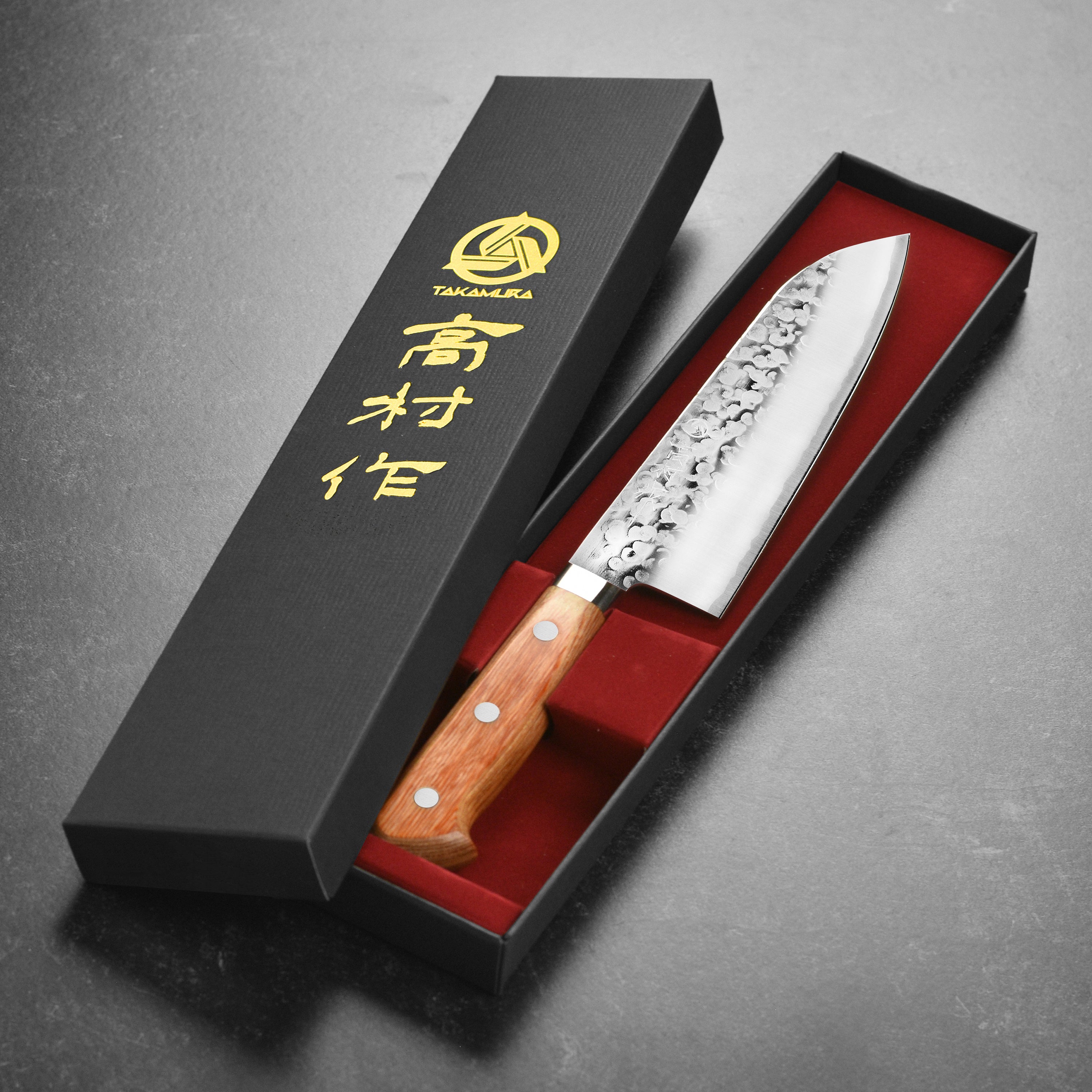 Detailed view of the sharp edge and hammered finish of Takamura Chromax Tsuchime Santoku knife