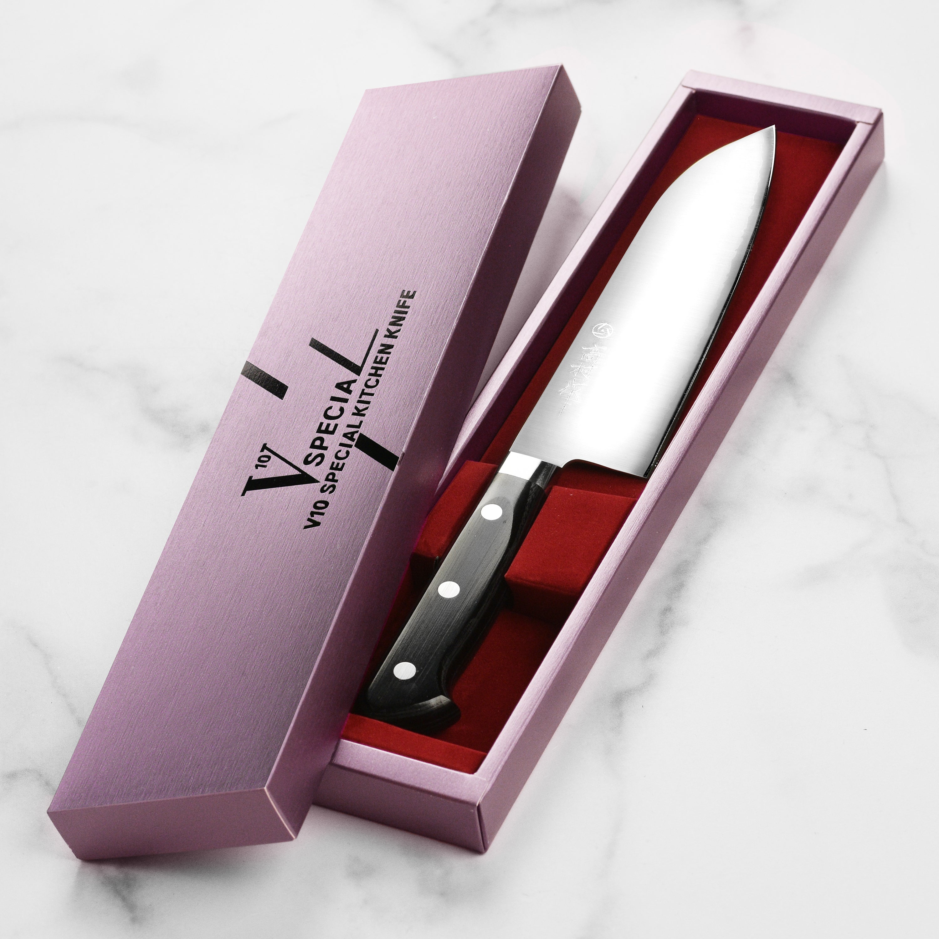 Takamura VG10 Santoku knife from above showcasing its sharp blade and ergonomic handle.