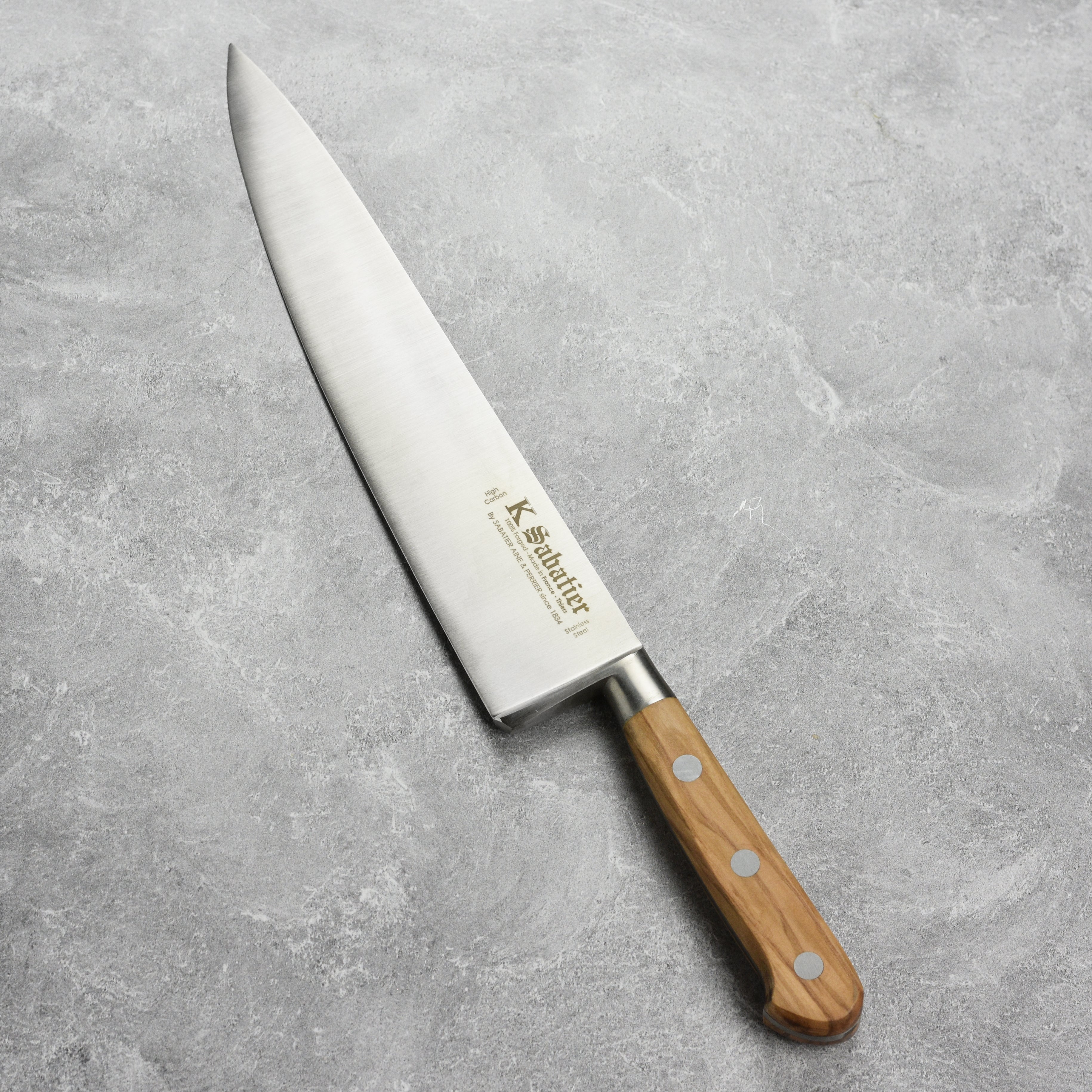 Side angle showing bolster and full-tang construction of the kitchen knife