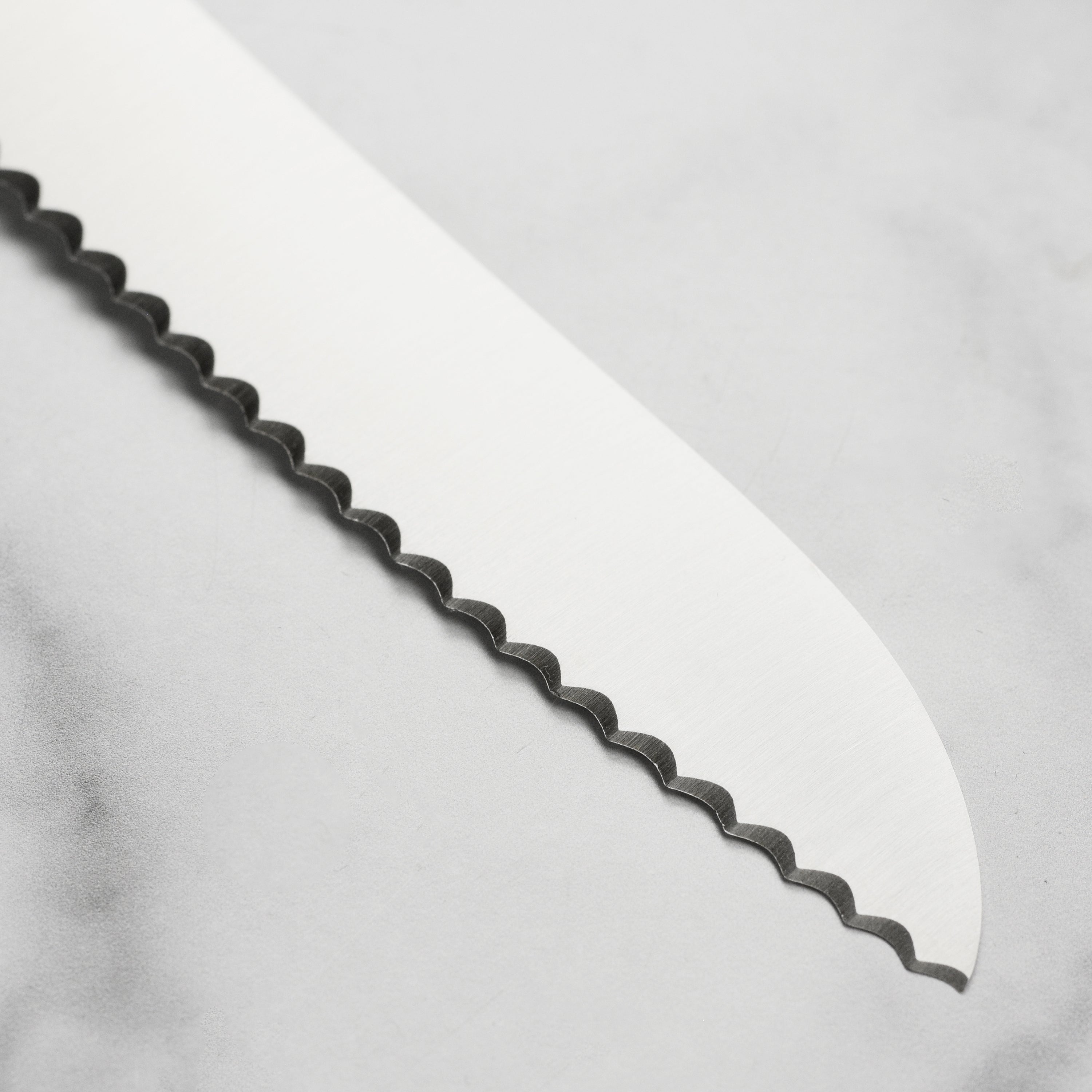 Close-up of the Sabatier knife showcasing its elegant olive wood handle and durable blade.