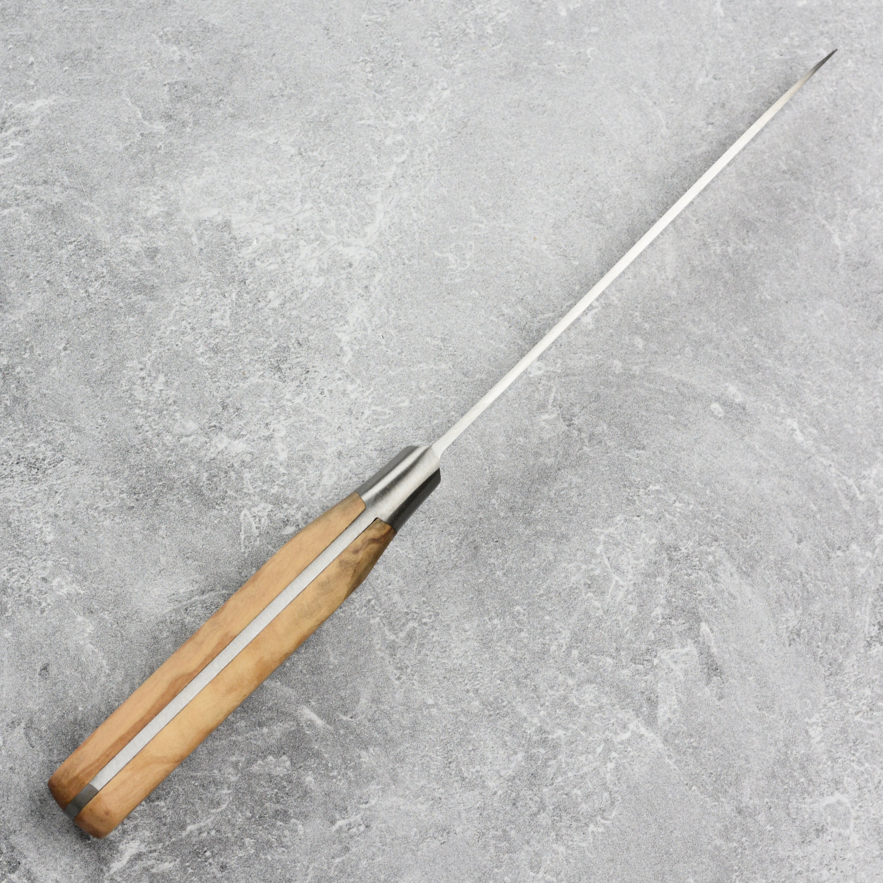 Full view of olive wood handle kitchen knife highlighting stainless steel rivets and classic French bolster