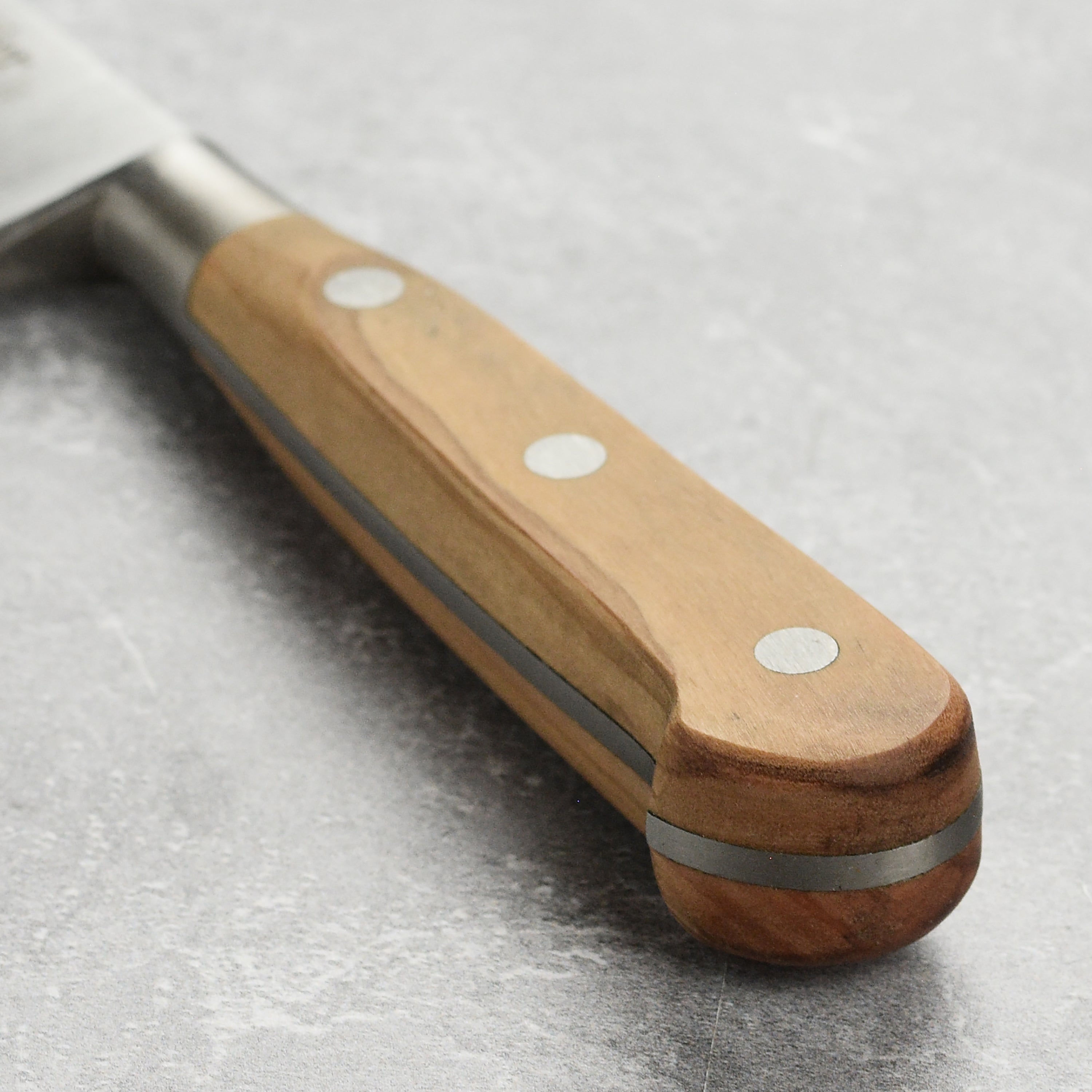 Close-up of the Sabatier Olive Wood Boning Knife highlighting the full-tang design and classic bolster