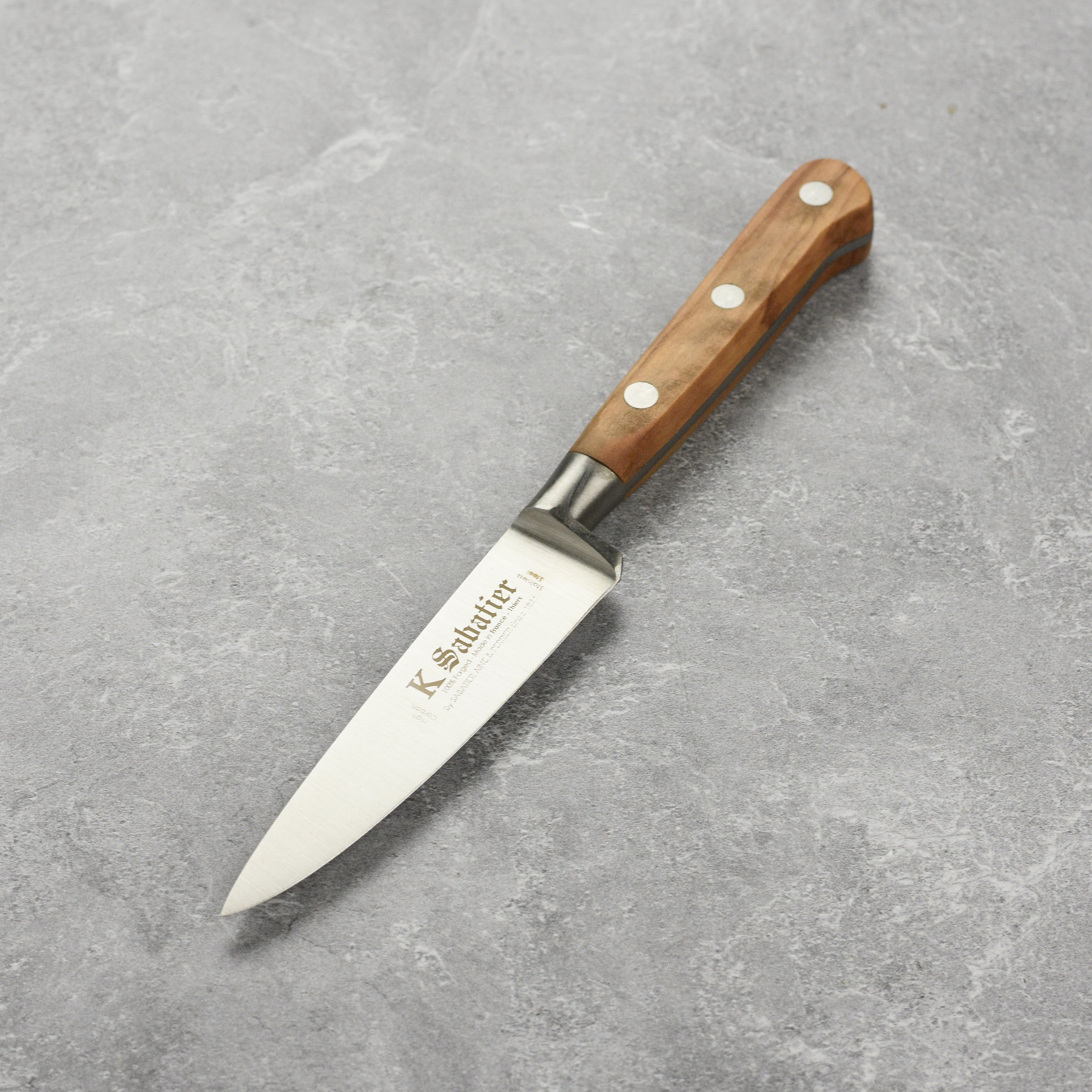 Close-up of the premium olive wood paring knife highlighting its elegant design and stainless steel blade.